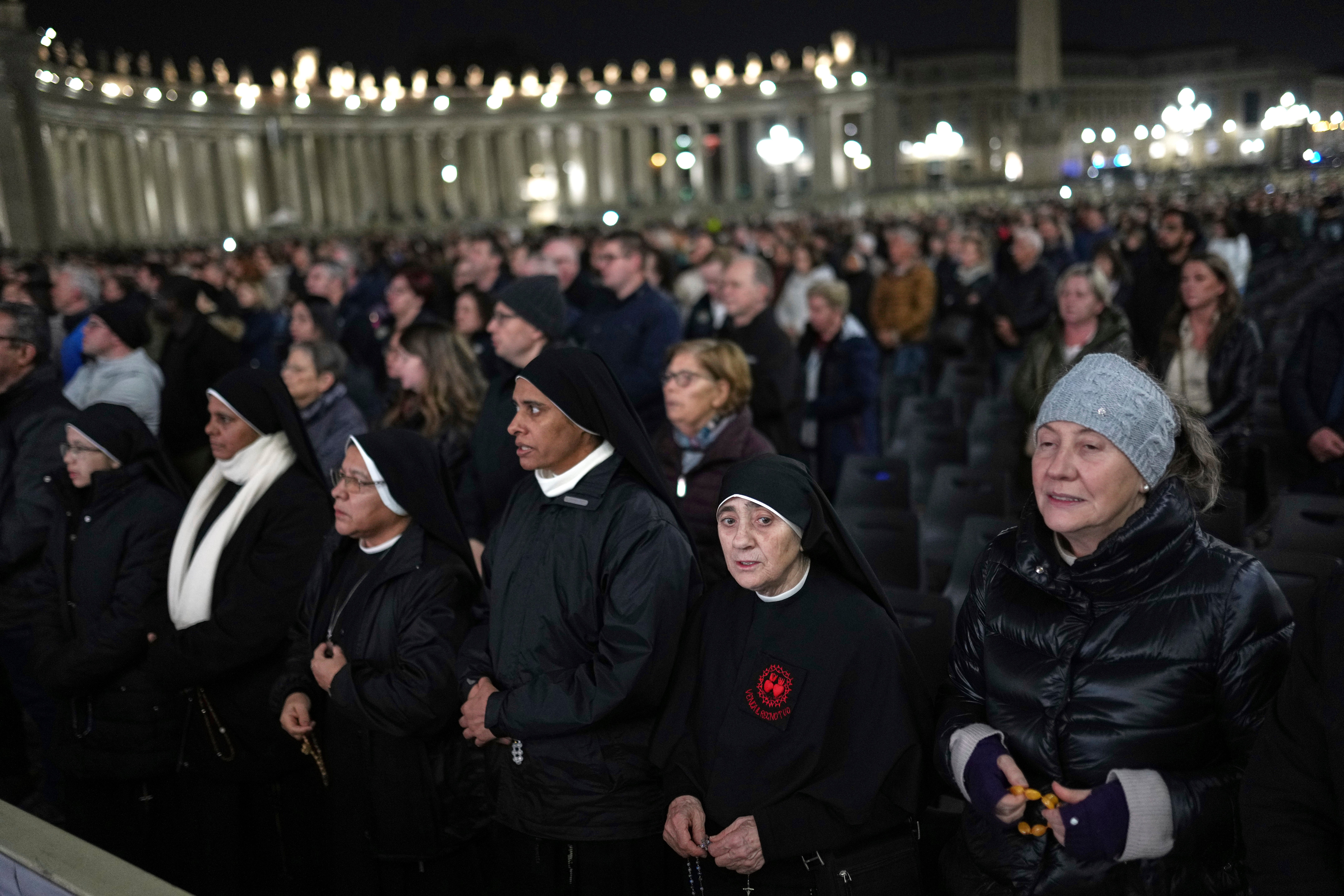 Catholic worshippers pray in St. Peter's Square at The Vatican