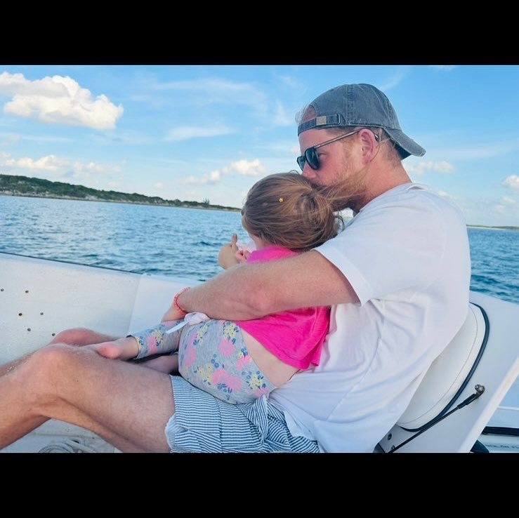 Harry on a boat with their daughter Lilibet