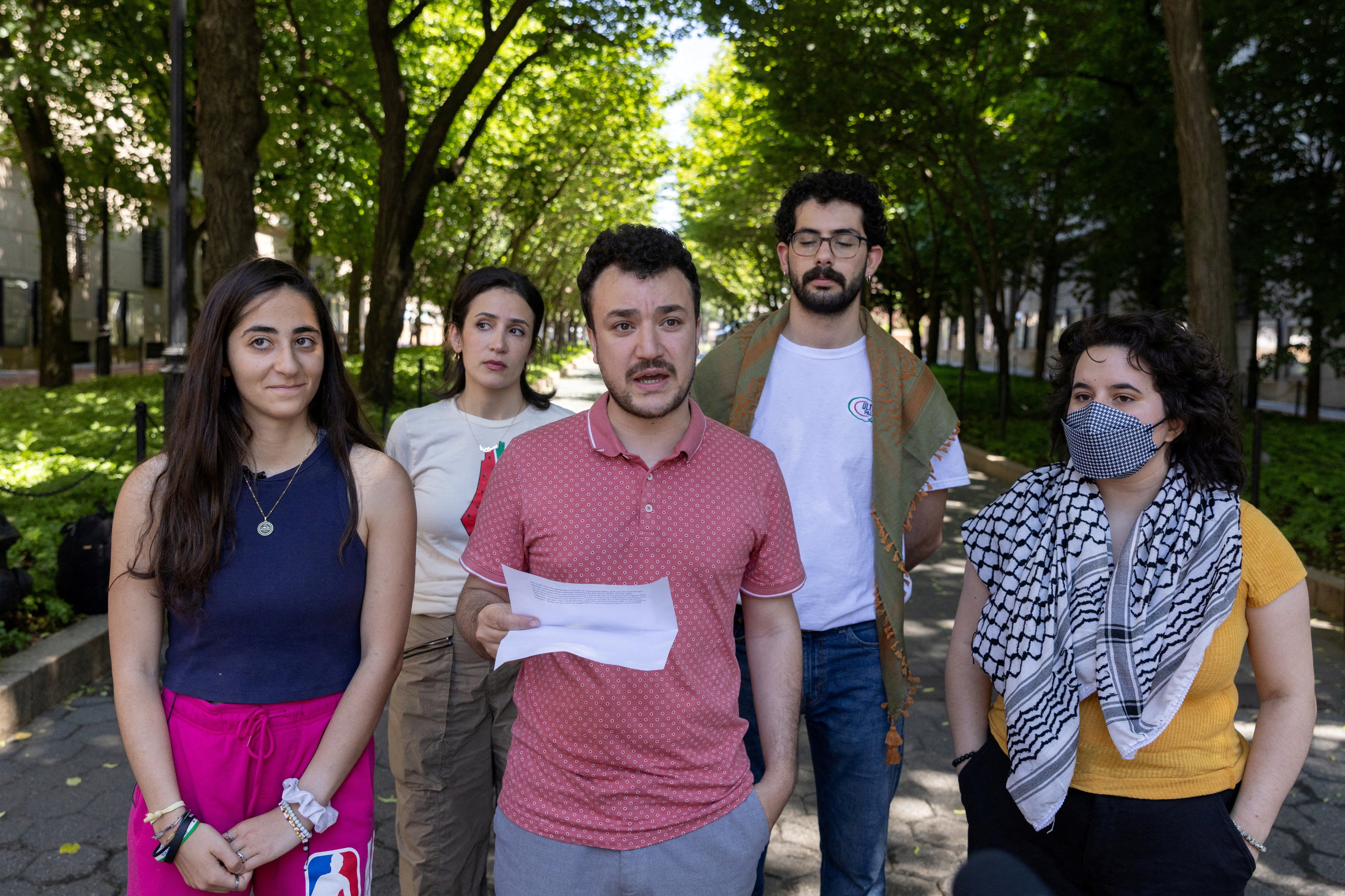Mahmoud Khalil, center, is pictured speaking to reporters about a Revolt for Rafah encampment at Columbia University in June 2024