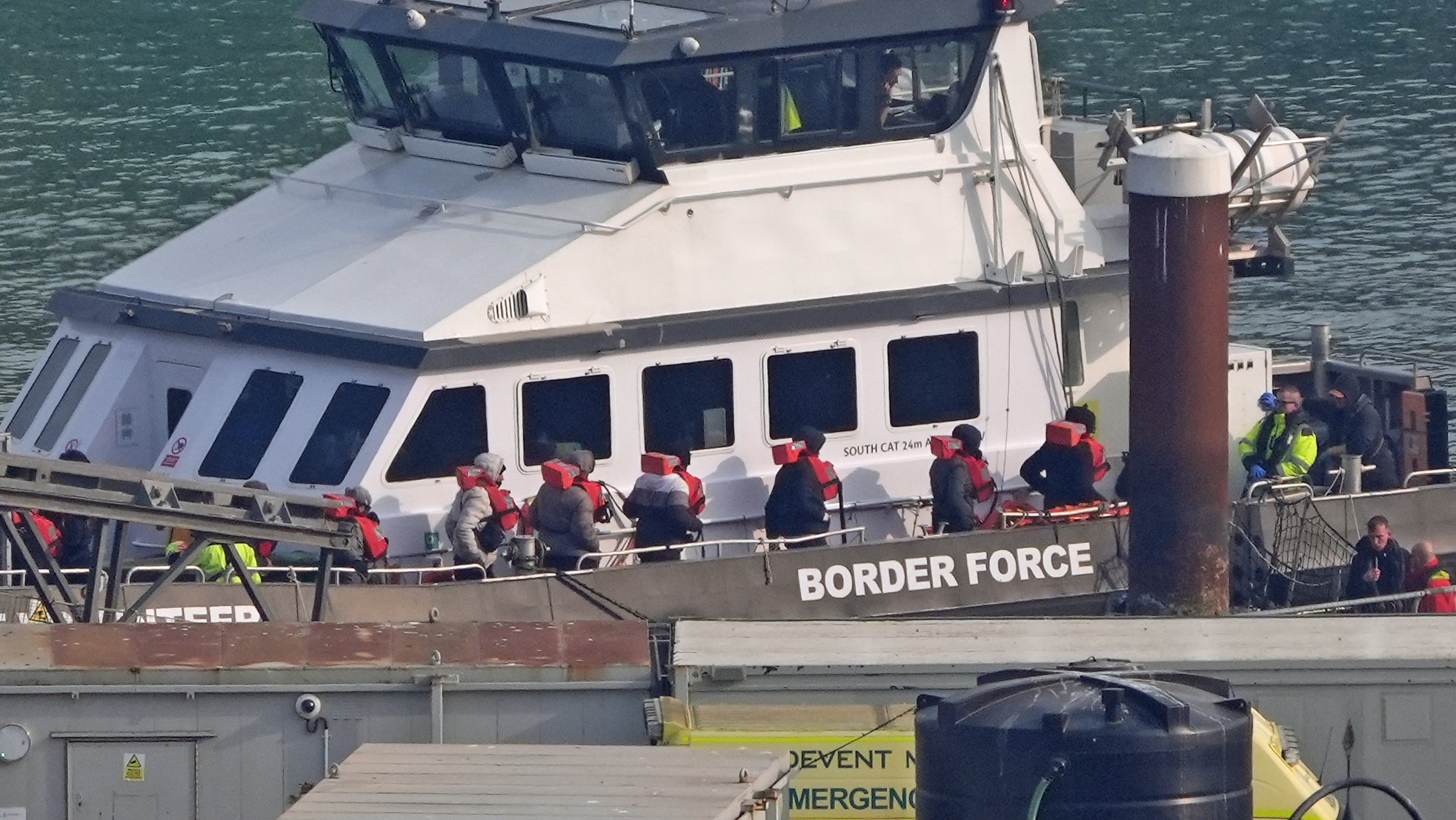 A group of people thought to be migrants are brought ashore to Dover on a Border Force boat following an incident in the Channel