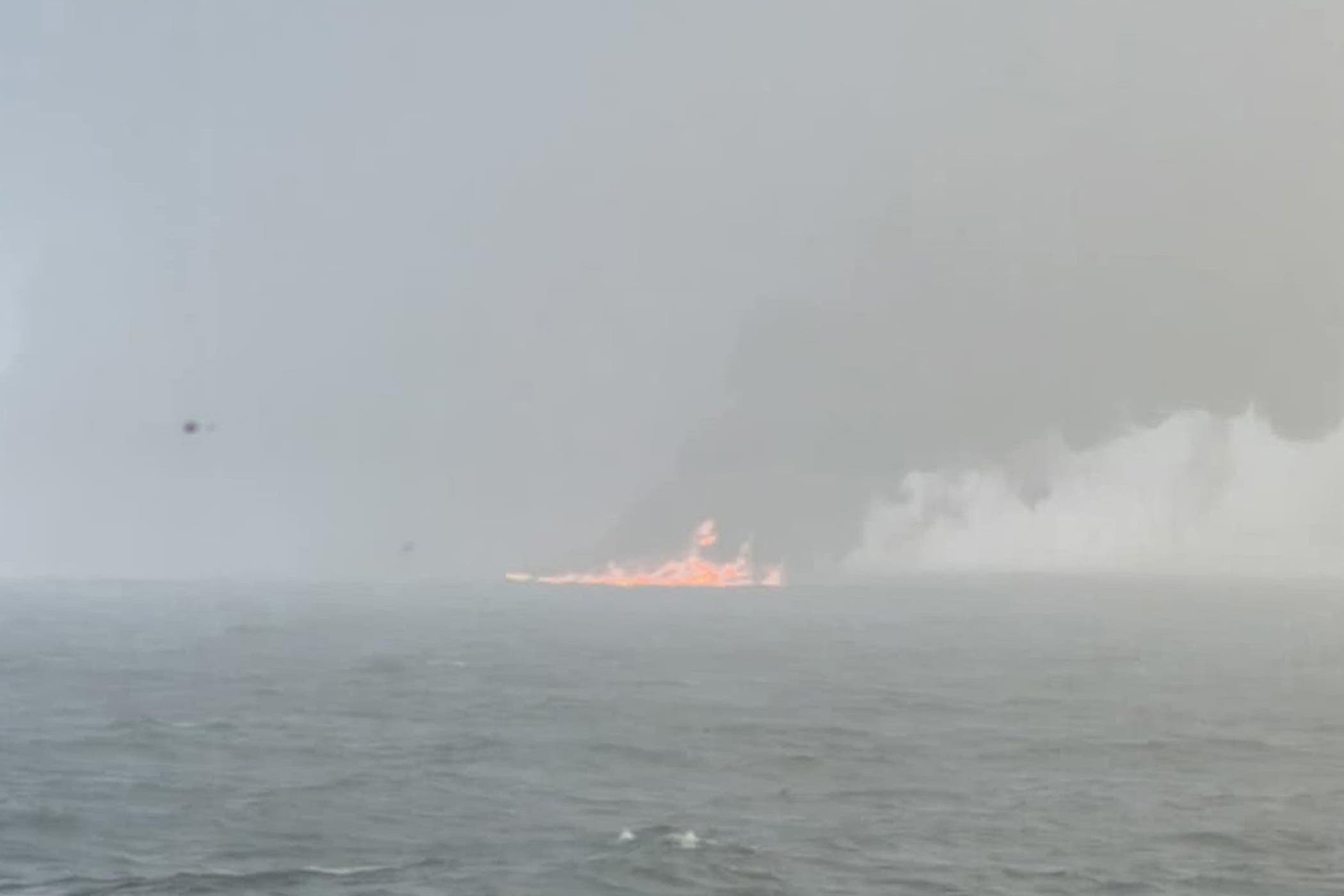 Handout photo of black smoke billowing into the air after a crash between an oil tanker and a cargo ship off the coast of East Yorkshire (Bartek Smialek/PA)