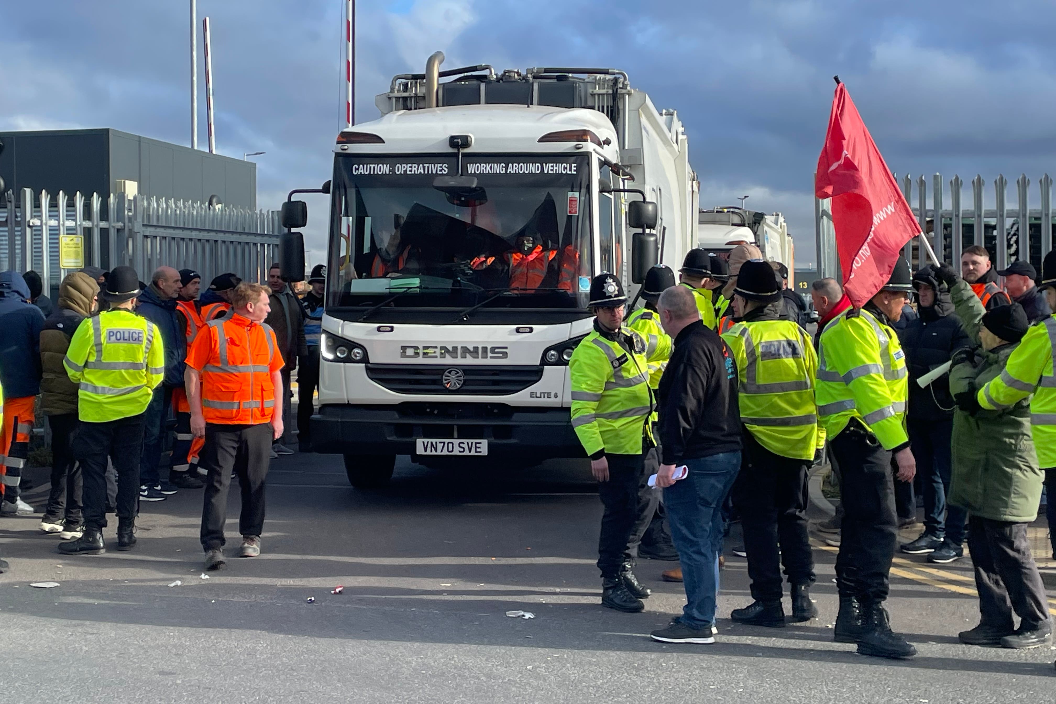 Police and workers on the picket line at Birmingham City Council’s Atlas Depot in Tyseley, Birmingham, as a bin lorry attempts to leave the site. (Matthew Cooper/PA)