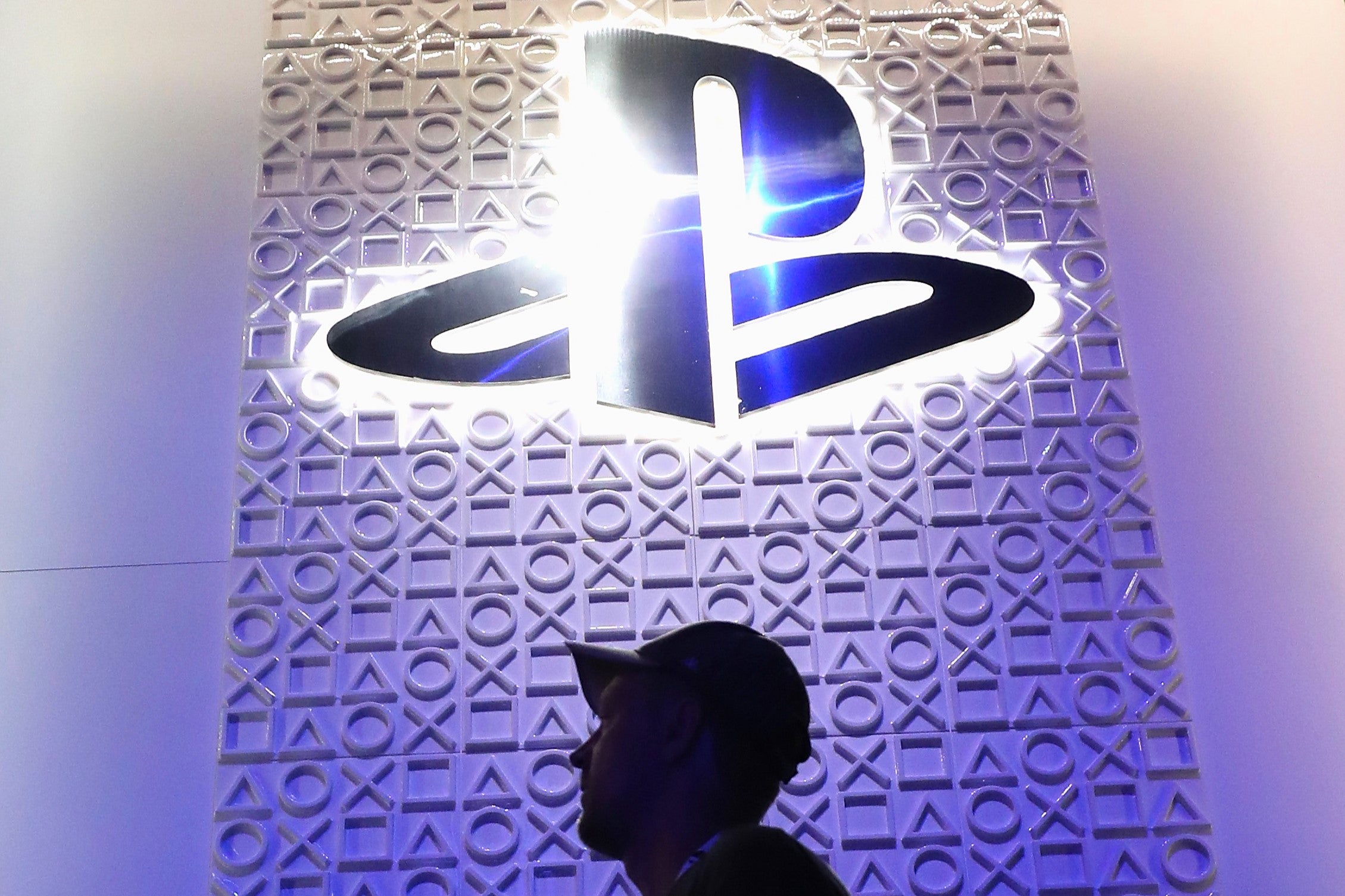 A man walks under a logo for Sony Playstation at the Los Angeles Convention Center on 12 June, 2018 in Los Angeles, California