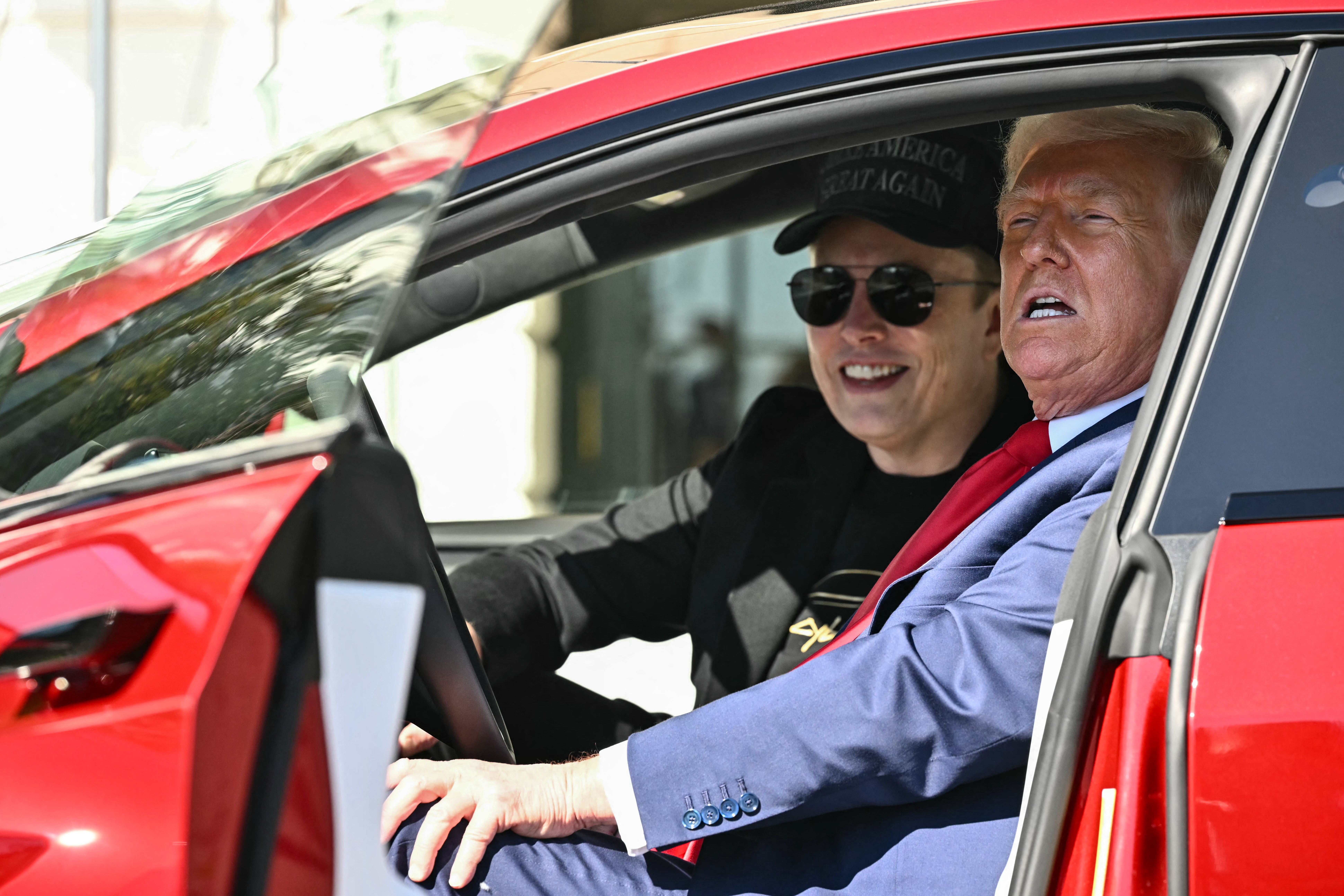 U.S. President Donald Trump and Elon Musk sit in a Tesla vehicle at the White House