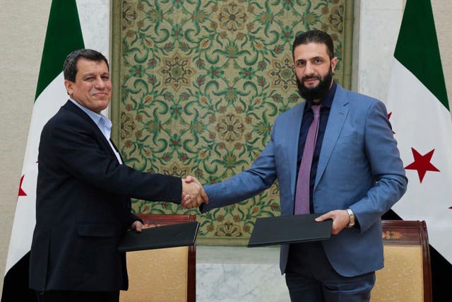 <p>Syria’s interim leader Ahmad al-Sharaa (right) shakes hands with Mazloum Abdi, commander of the Syrian Democratic Forces, in Damascus on Monday</p>