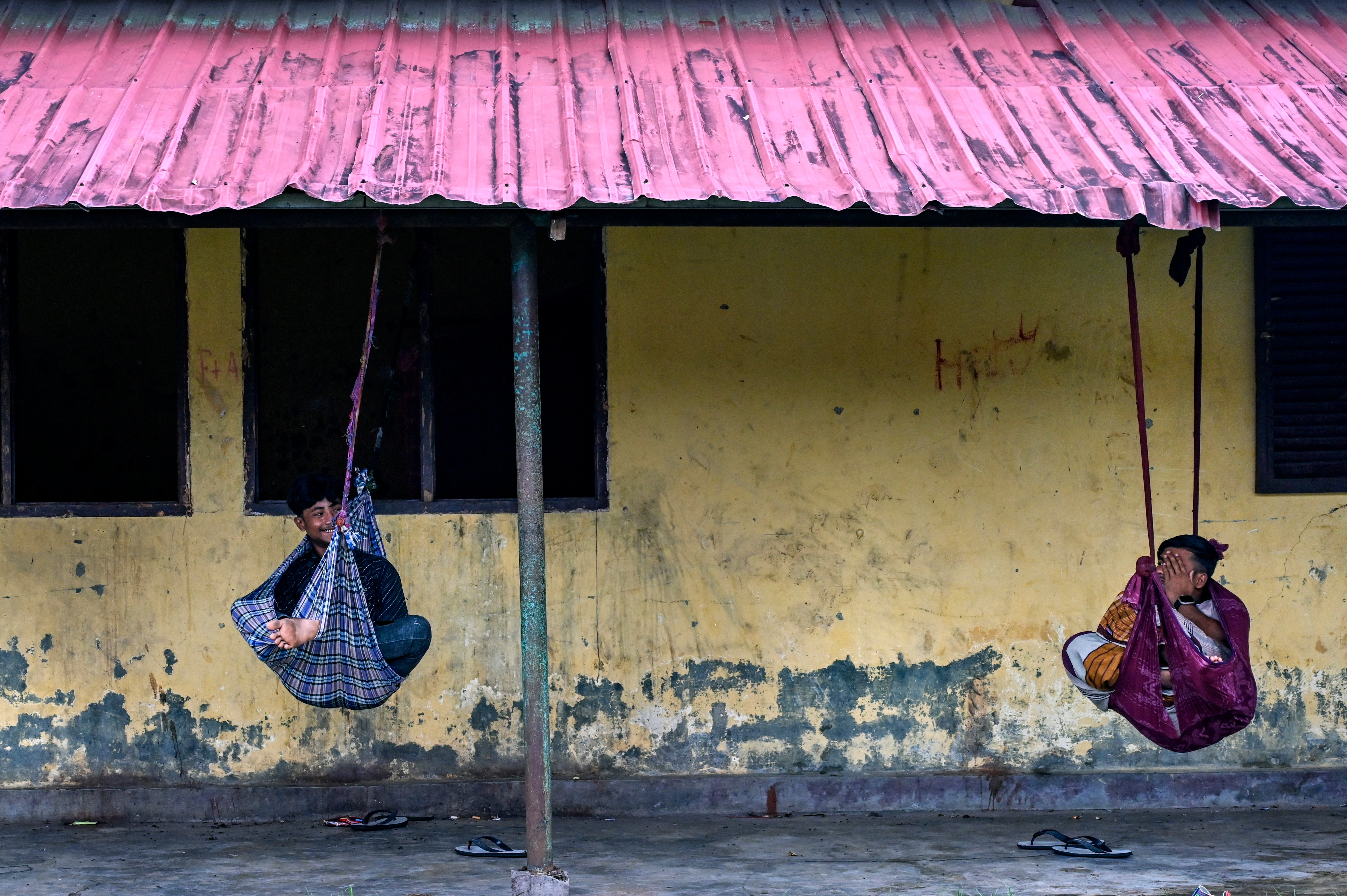 People rest in hammocks at a camp for Rohingya refugees in Padang Tiji, Indonesia's Aceh province
