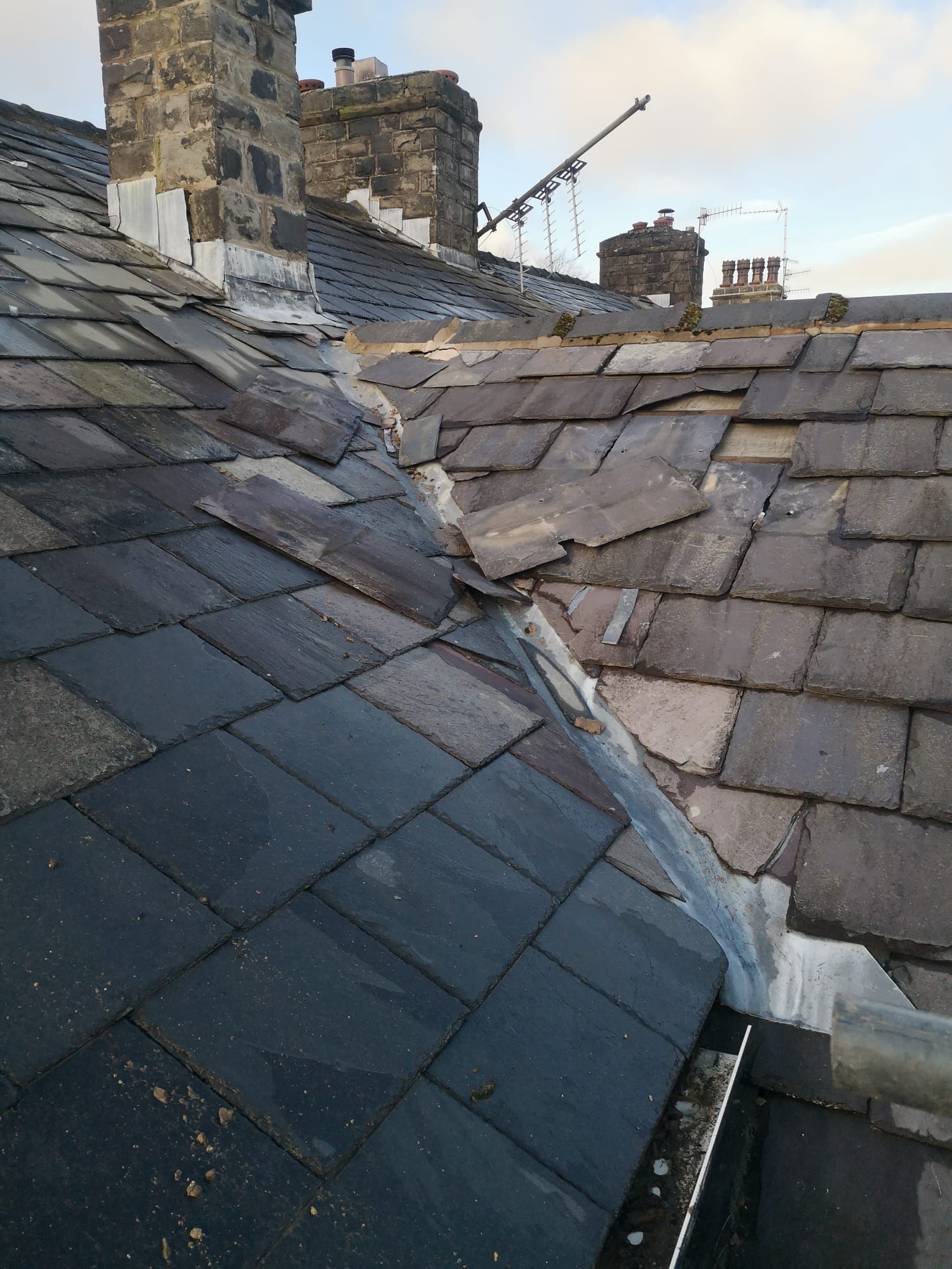 Large sections of slate began to slide off of the roof, posing a risk to parked cars and the public