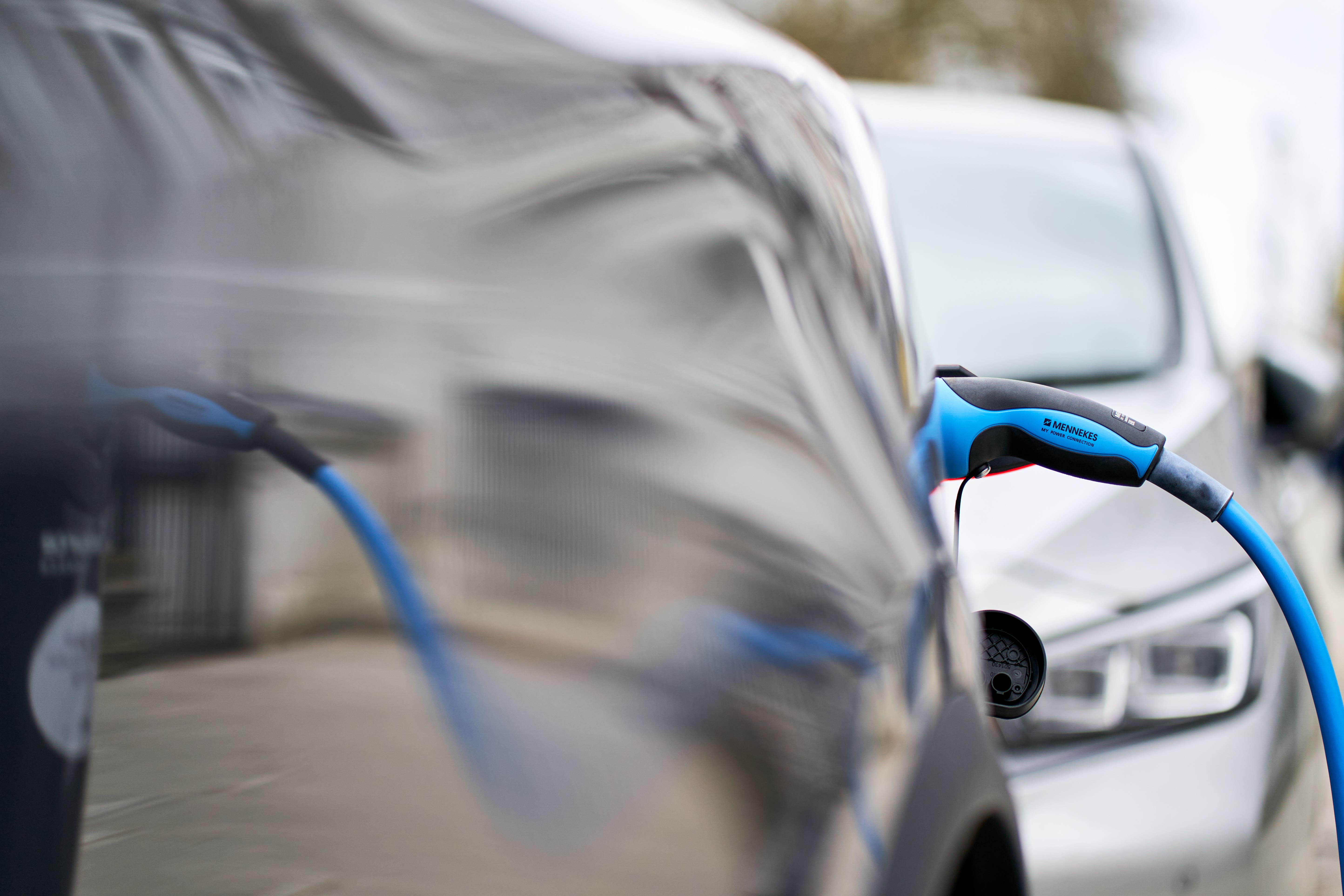 A Tesla car plugged into a Source London EV charging point in central London (John Walton/PA)