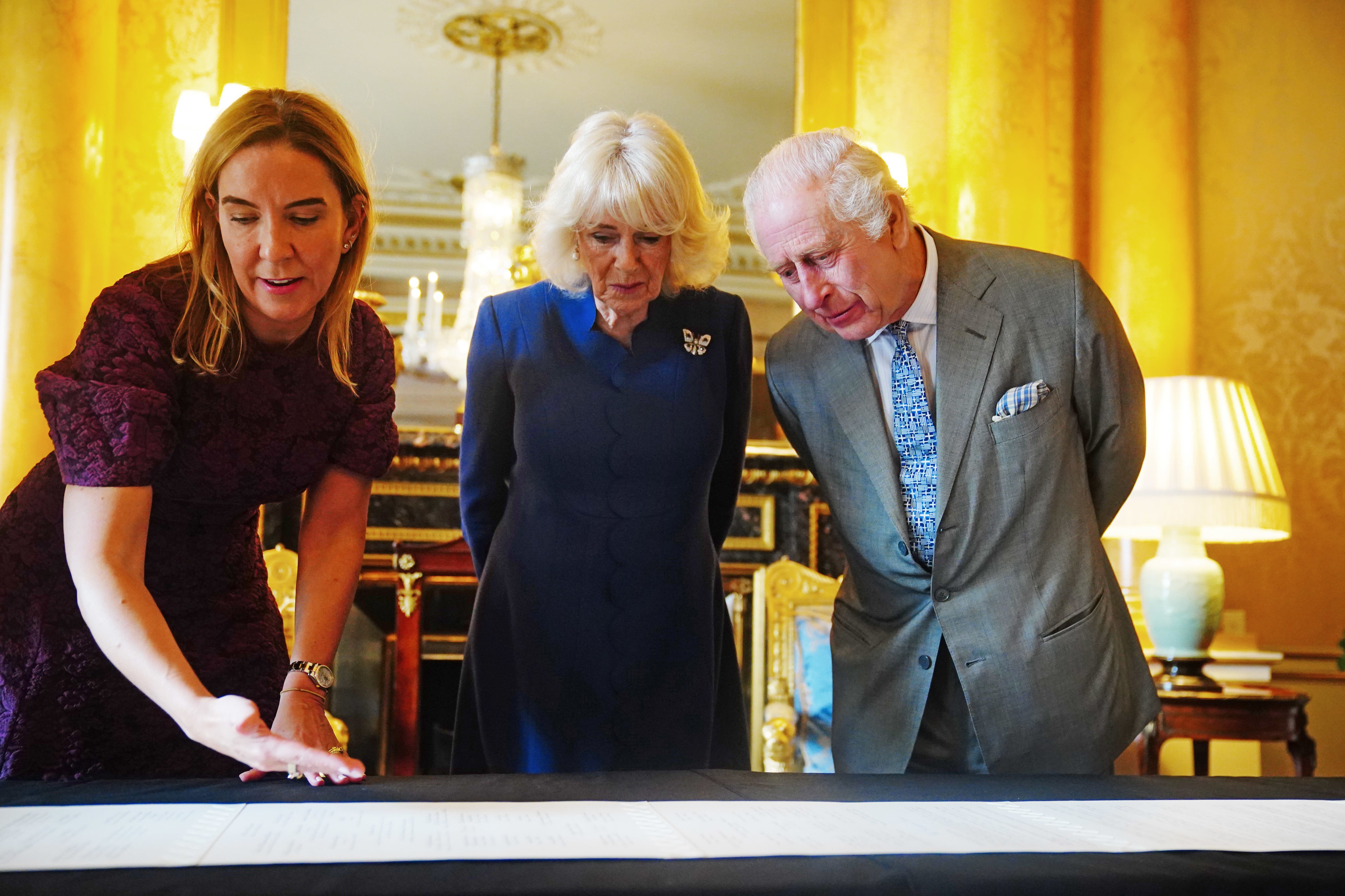 Dame Antonia Romeo presenting the King and Queen with the Coronation Roll, an official record of their Coronation (Victoria Jones/PA)