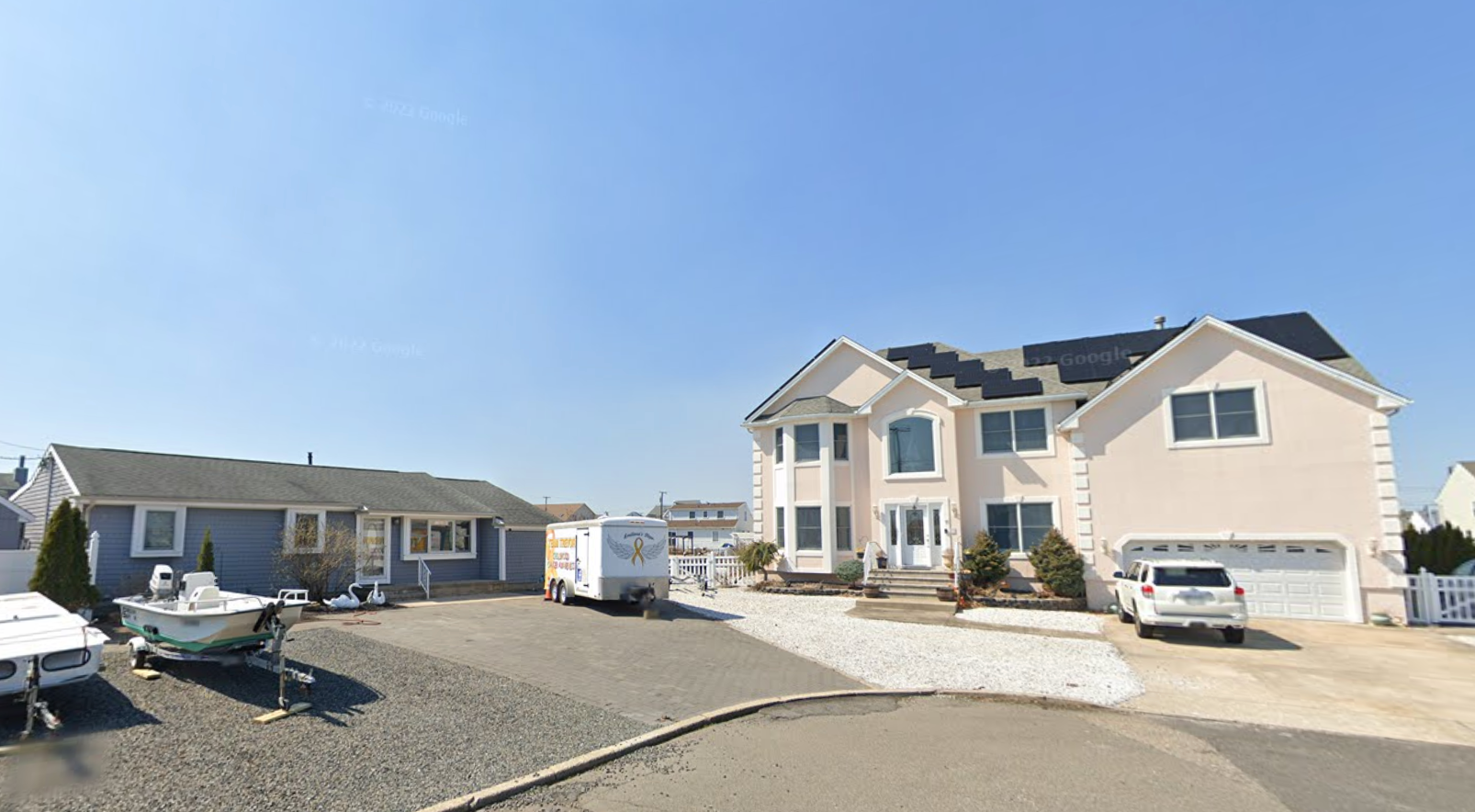 Tom and Jill Kwatkoski live in a modest home beside John Adamo's million-dollar spread