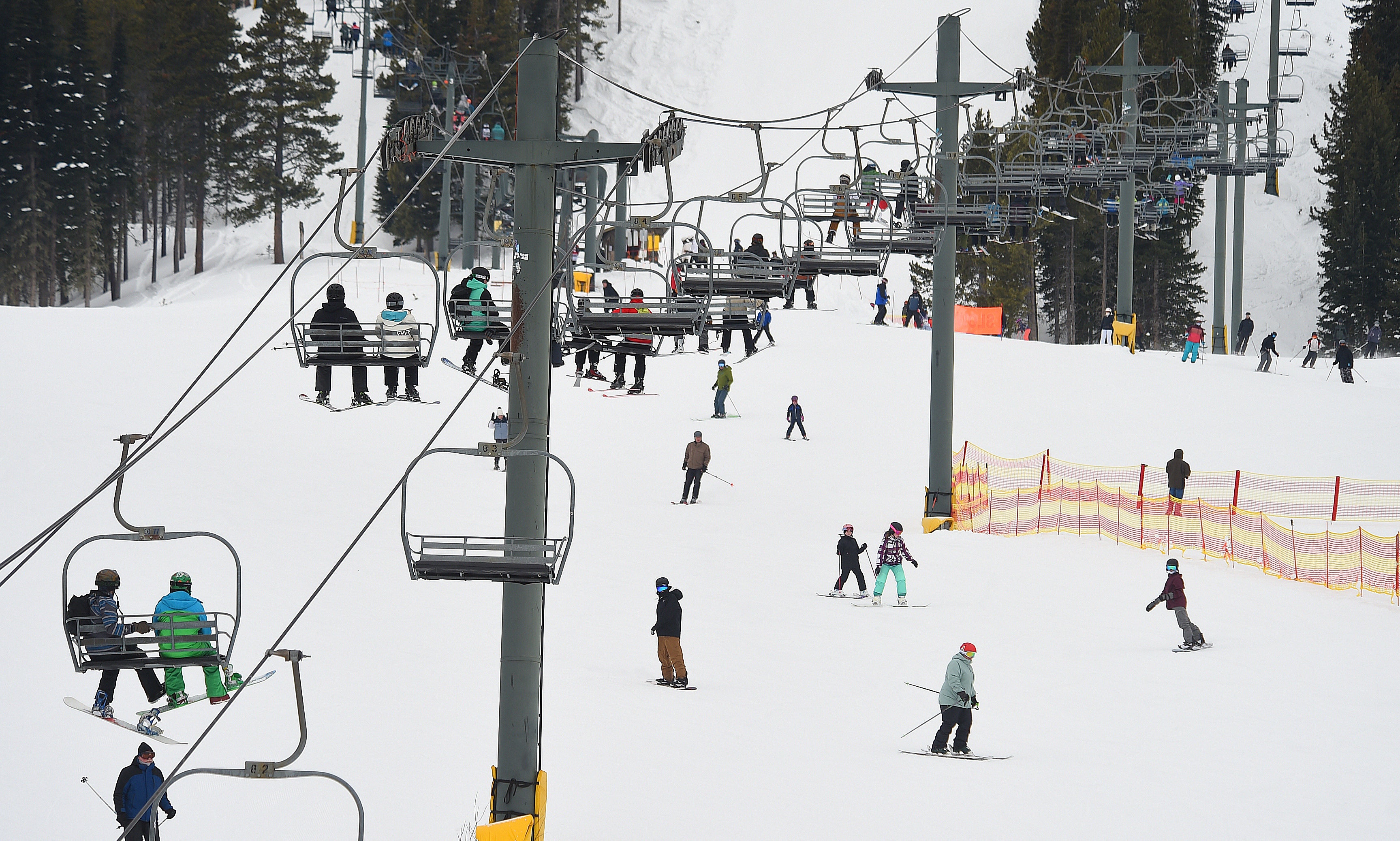 People are seen riding a chairlift at Red Lodge Mountain in 2023