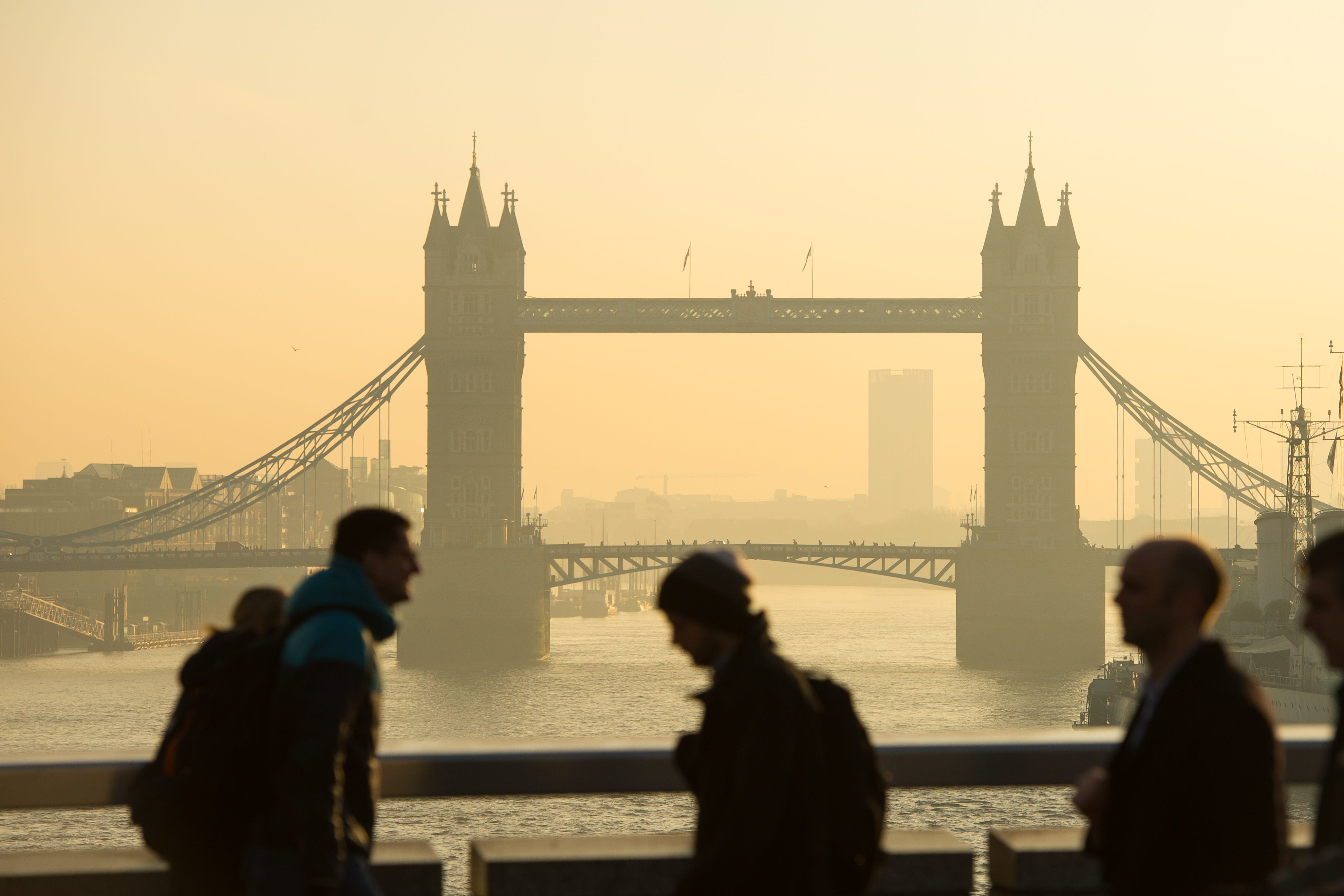 Commuters are seen with Tower Bridge, in central London as they cross London Bridge during morning rush hour (Dominic Lipinski/PA)