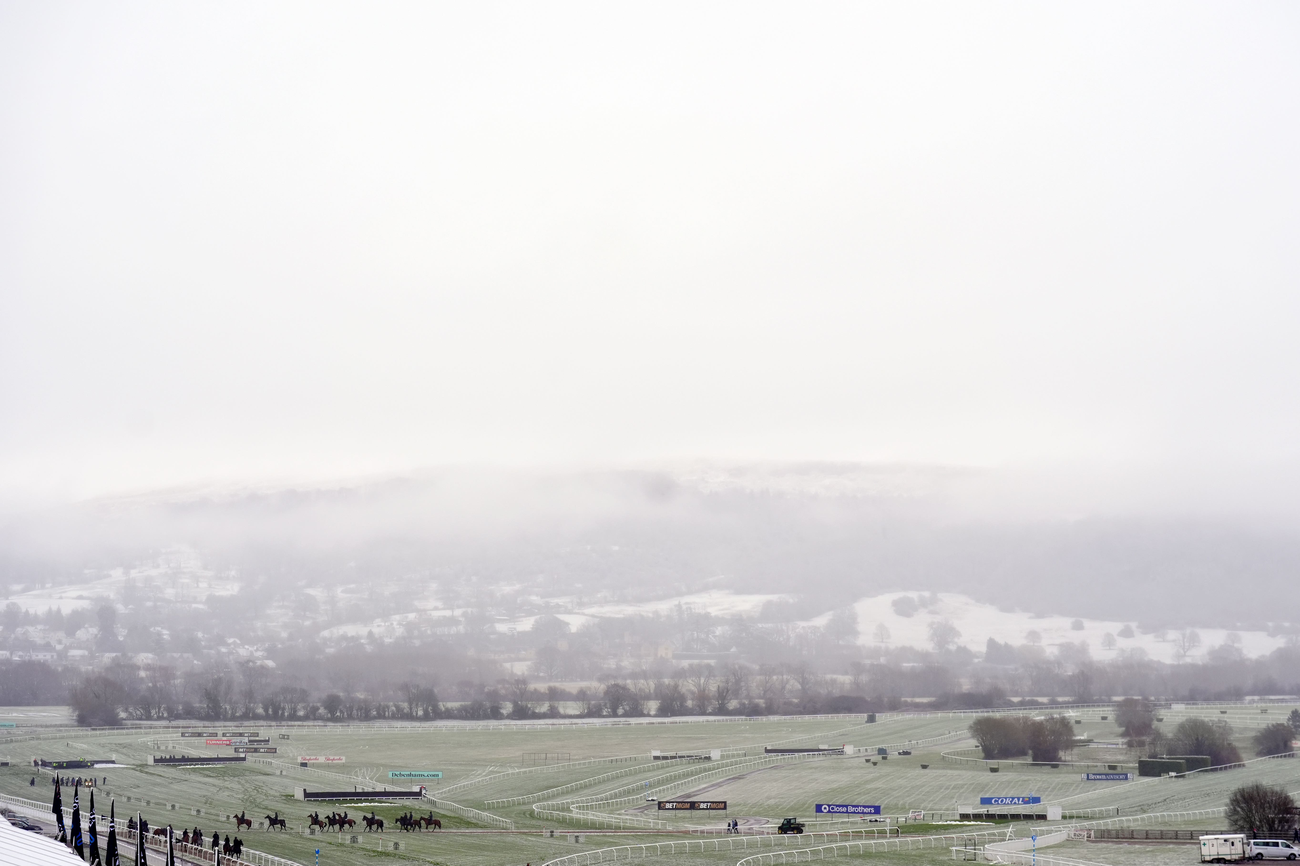 Horses make their way in from the snow covered gallops on day two of the 2025 Cheltenham Festival (Mike Egerton/PA)