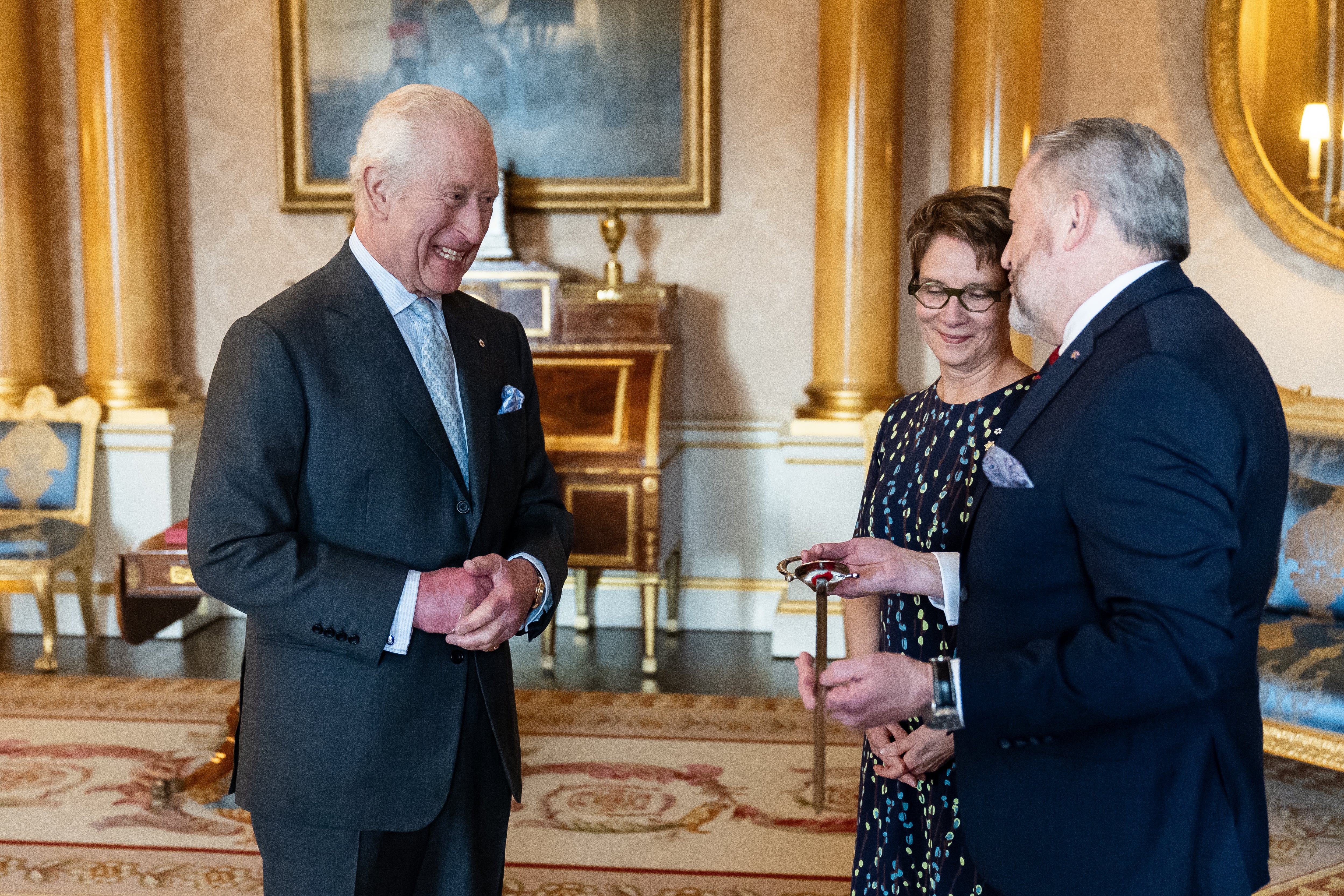 <p>King Charles III bestows a new ceremonial sword to the Usher of the Black Rod of the Senate of Canada Gregory Peters with Speaker of the Senate of Canada Raymonde Gagne present </p>