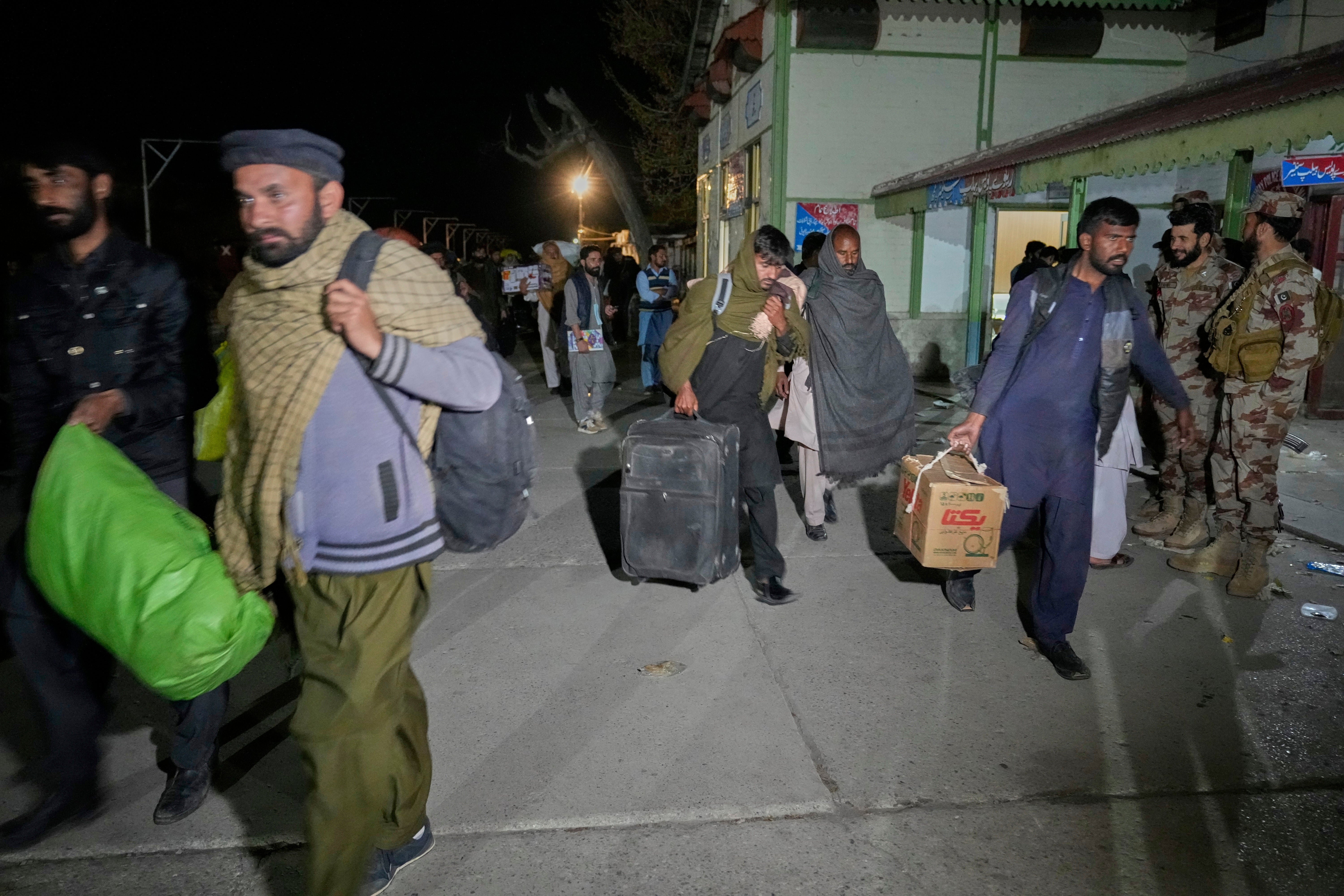 Passengers rescued by security forces from a train attacked by Baloch insurgents arrive at a railway station in Much, Pakistan, on 13 March 2025
