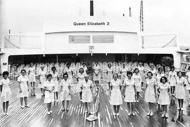 The QE2 cleaners pose on deck in 1975 (Mirrorpix/PA)