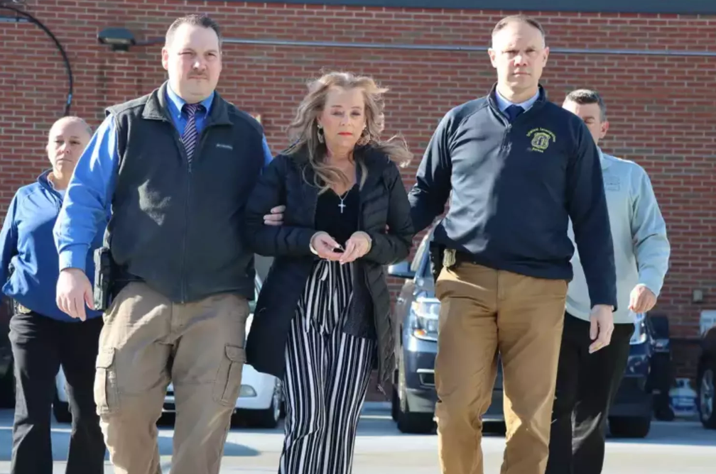 Kimberly Sullivan, 56, is flanked by police during her arraignment on March 12, 2025, after she allegedly kept her stepson captive in his bedroom with little food or water for 20 years