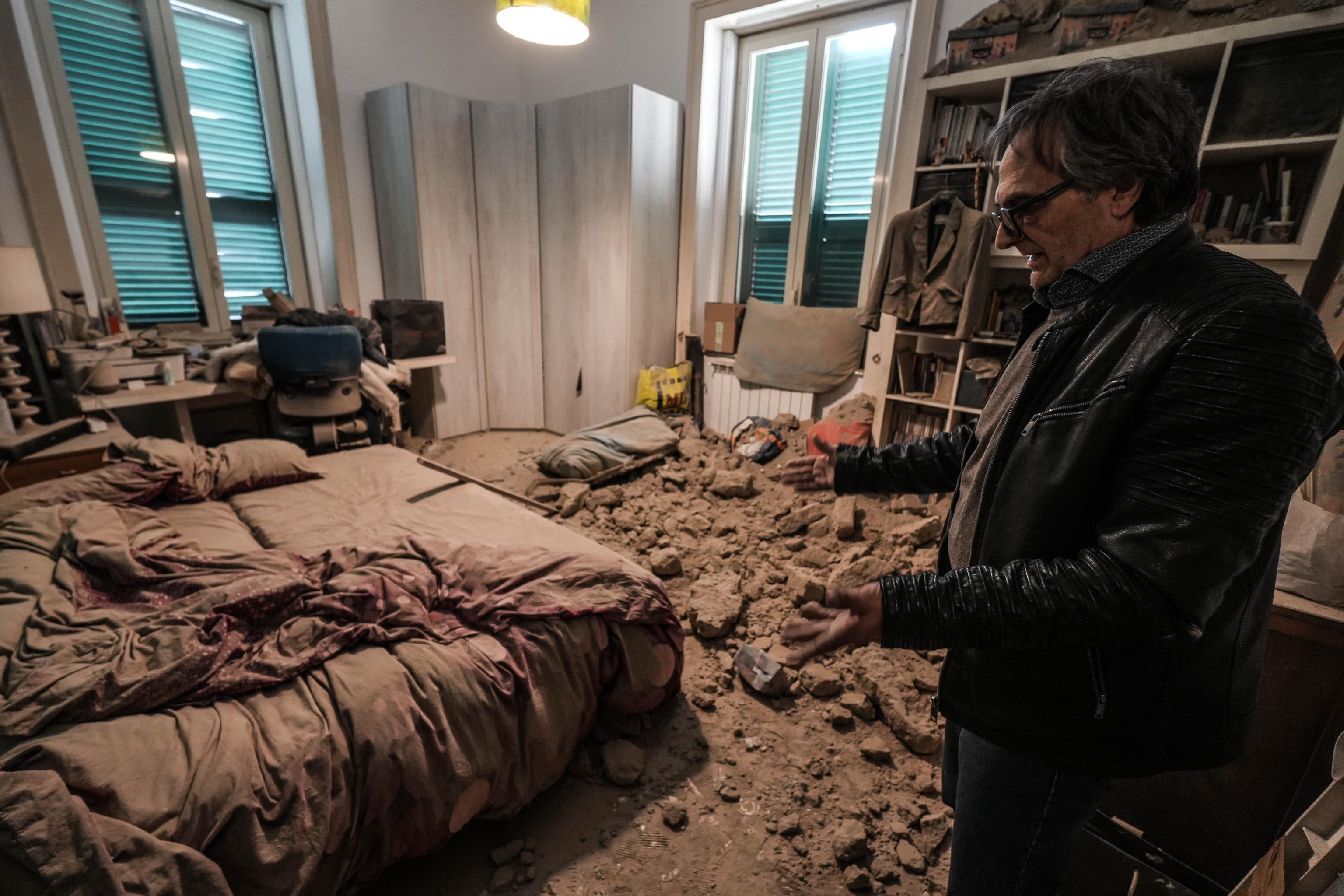 A resident of Bagnoli, southern Italy, exmaines the damage caused by an earthquake in March