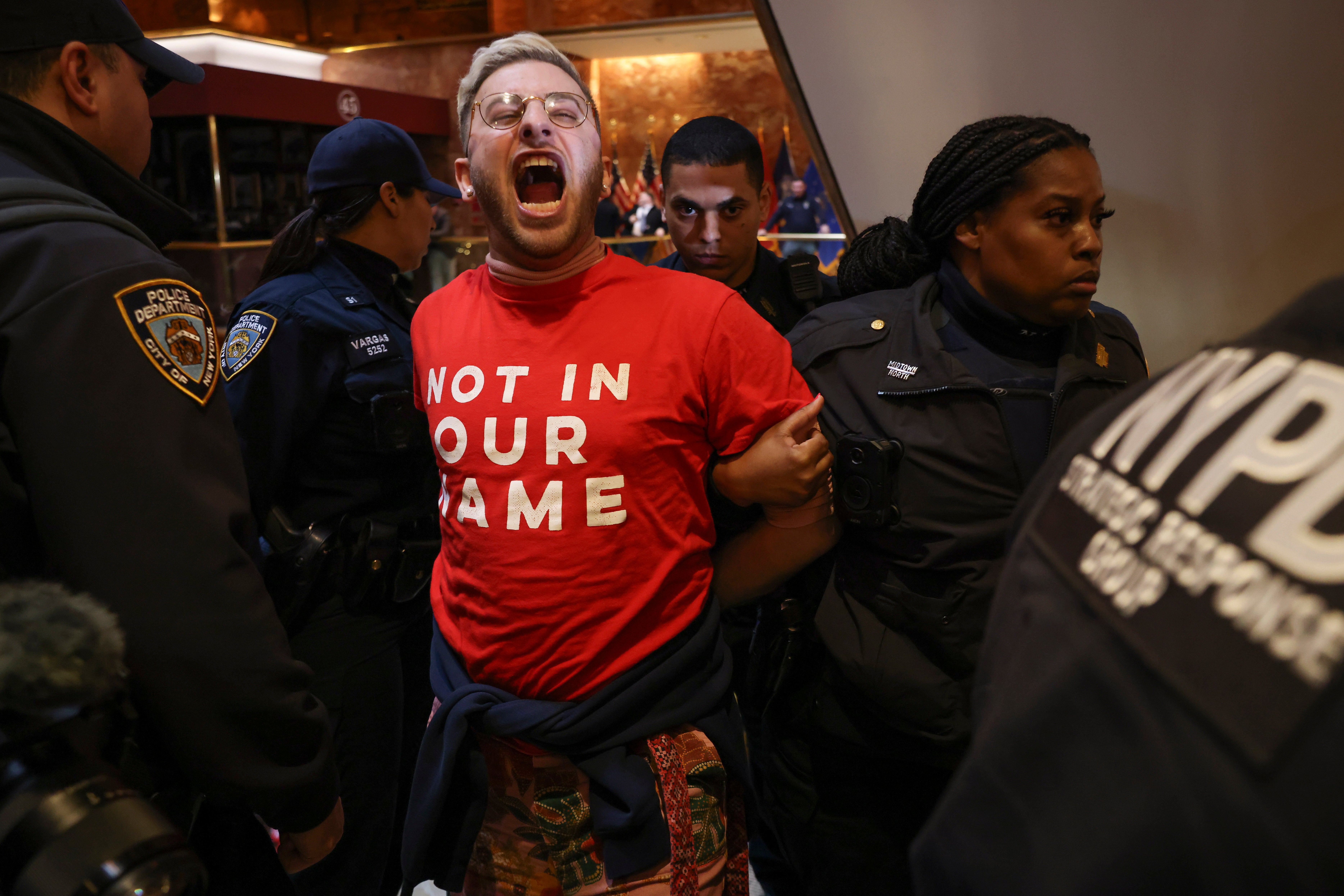 New York Police officers arrest a demonstrator from the group, Jewish Voice for Peace, who protested inside Trump Tower in support of Columbia graduate student Mahmoud Khalil on Thursday