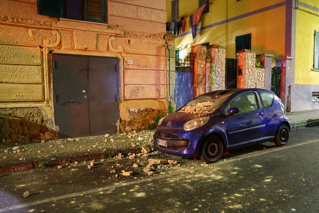 <p>A damaged car is seen in the street after an overnight earthquake in Naples</p>