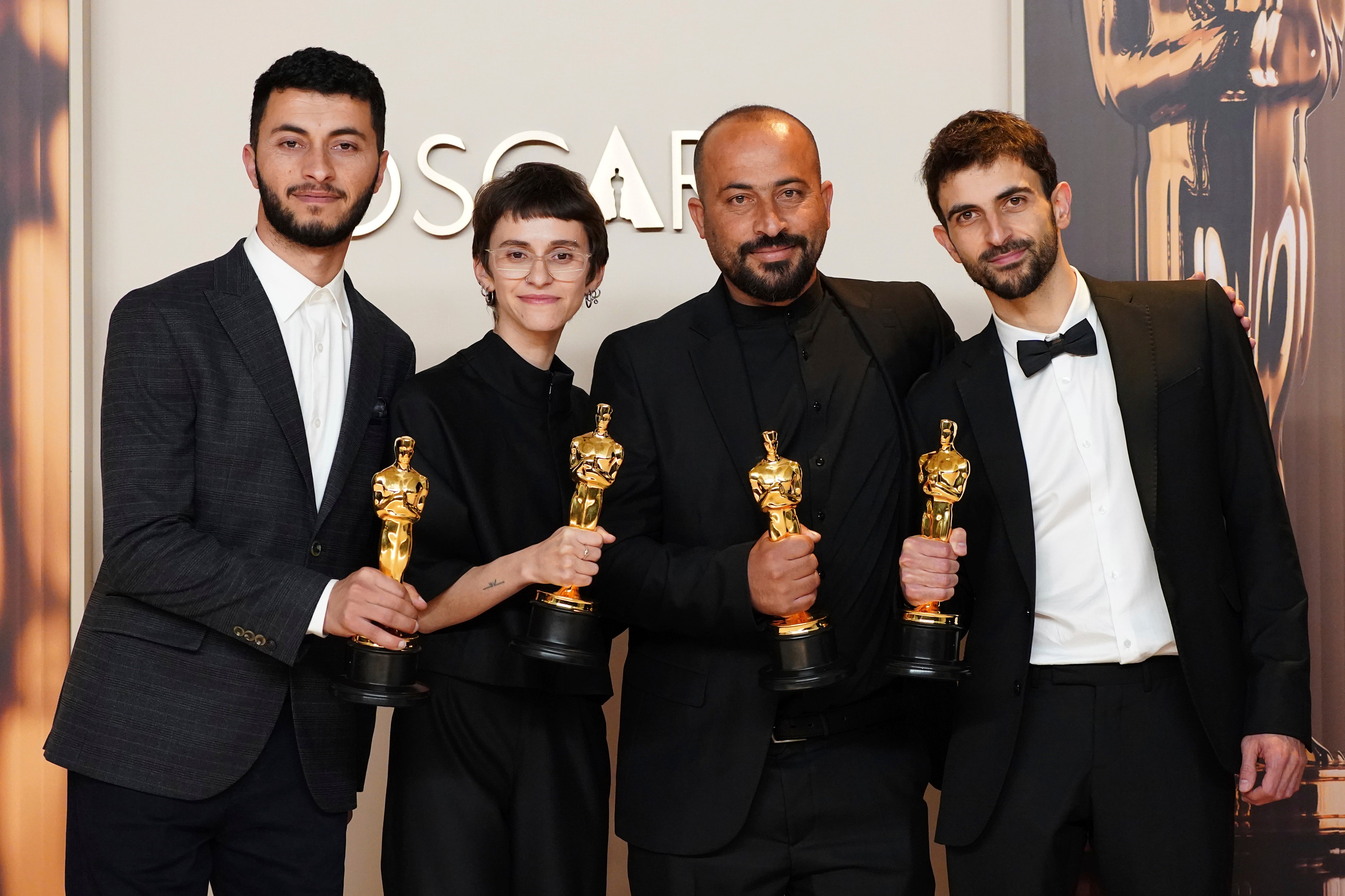 (L-R) Basel Adra, Rachel Szor, Hamdan Ballal and Yuval Abraham standing with their Oscars after their film, ‘No Other Land,’ won Best Documentary Feature