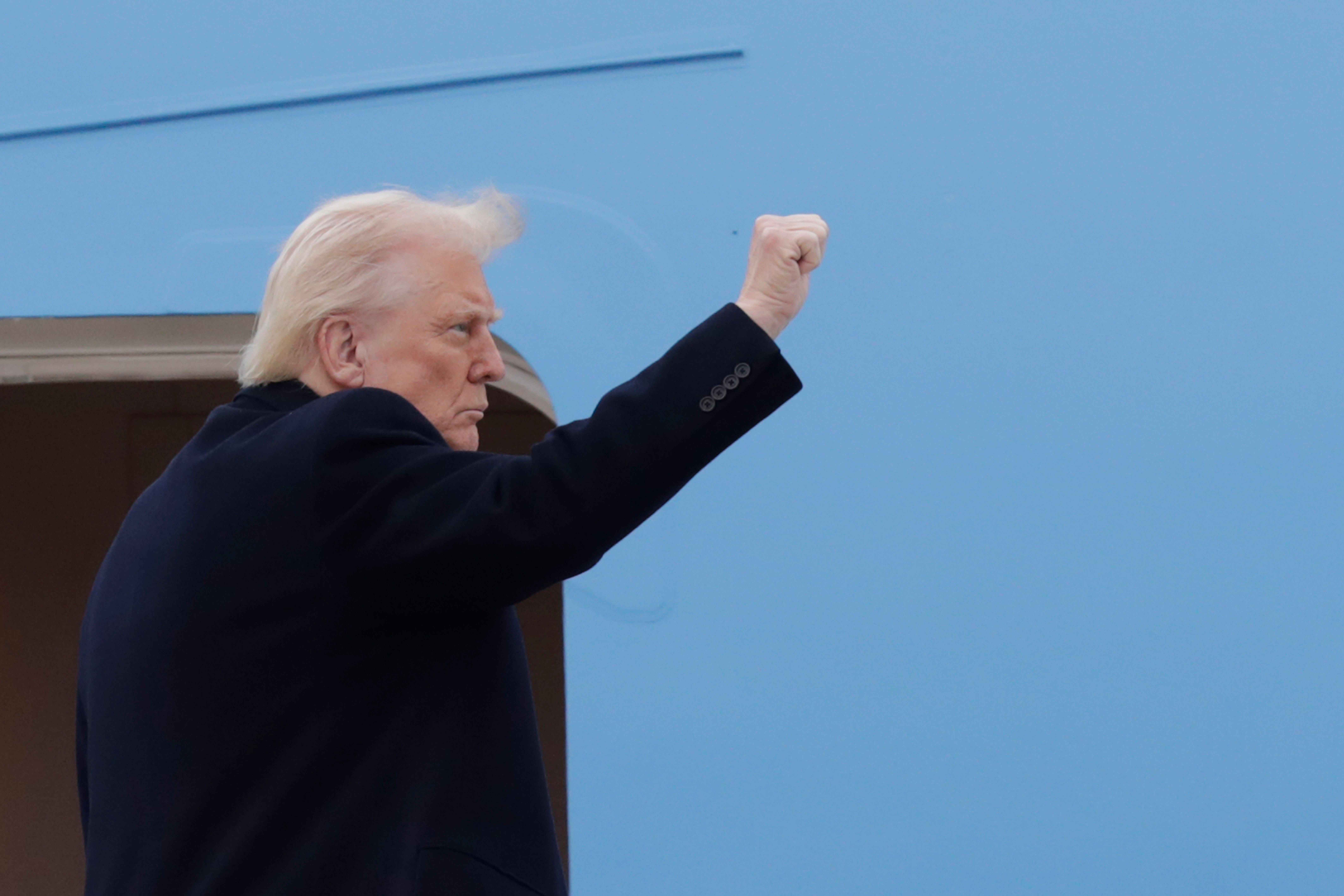Trump gestures outside Air Force One