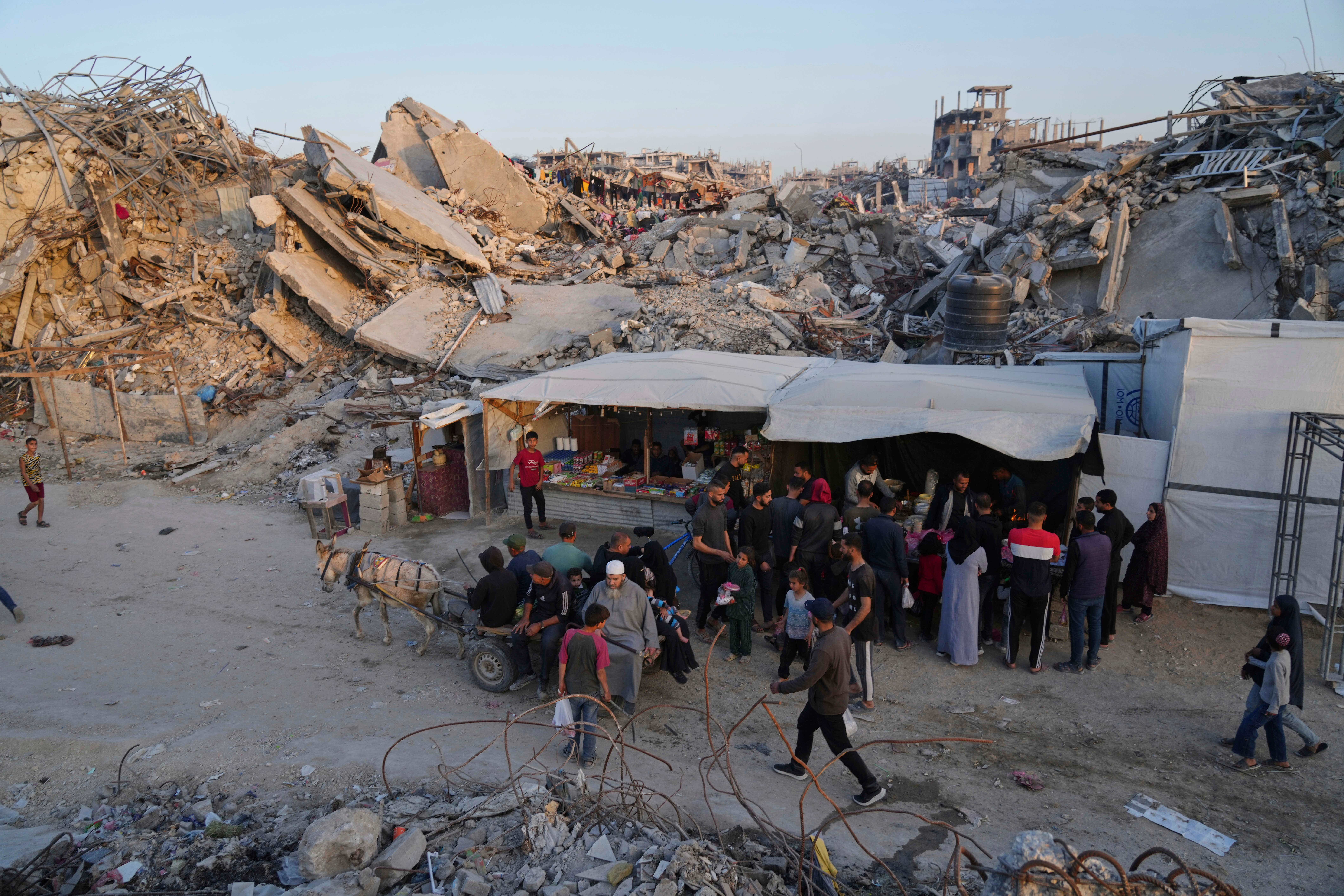 Palestinians walk amid the rubble of destroyed homes and buildings in Jabaliya in the northern Gaza Strip (Jehad Alshrafi/AP/PA)