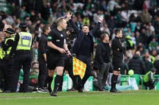 Celtic fans restrained by police after Rangers player sprays water on them in fiery Old Firm clash