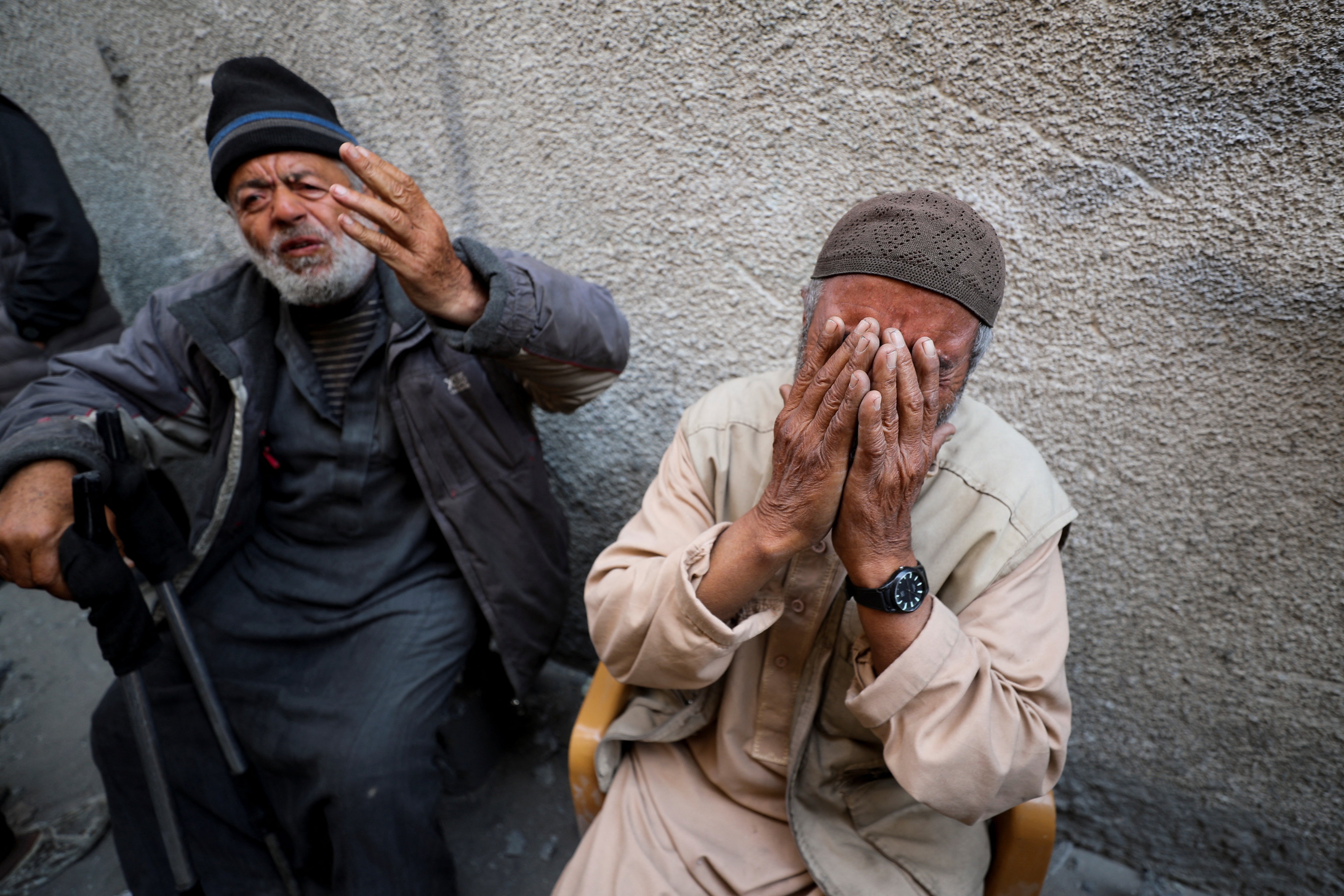 Palestinians react at the site of an Israeli strike on a residential building in Jabalia