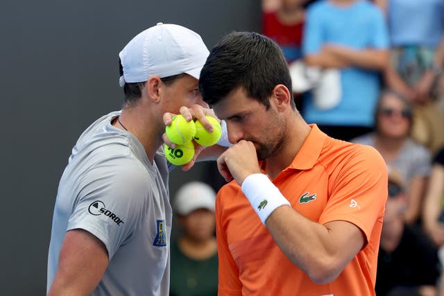 <p>Canada's Vasek Pospisil and Serbia's Novak Djokovic talk tactics during their double match against during their Round of 32 match at the Adelaide International Tennis tournament in Adelaide, Australia, Jan. 2, 2023</p>