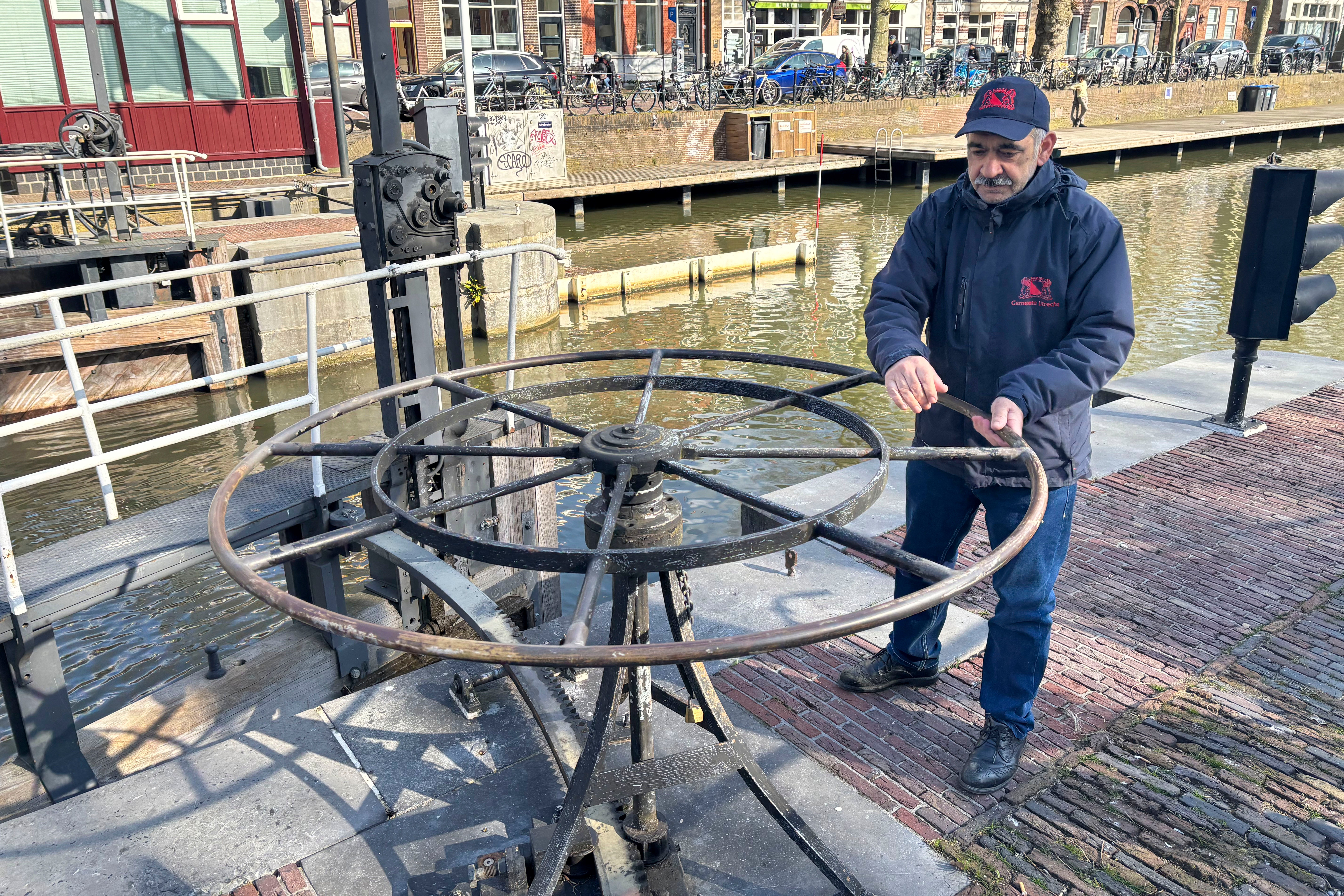 Rashid Ouchene opens the lock in Utrecht, Netherlands,, where a "fish doorbell" was installed