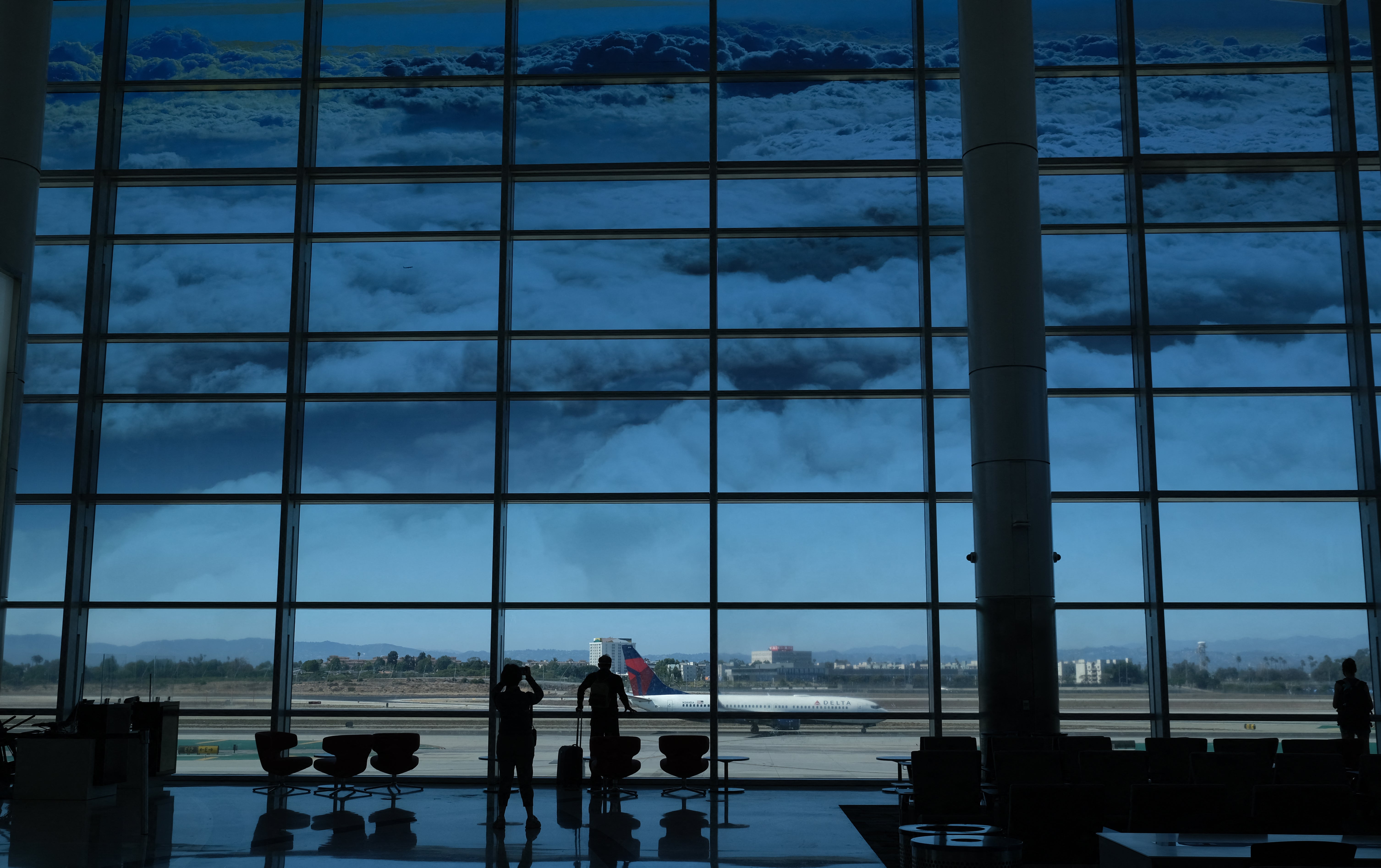 A Delta Airlines flight seen from a window at Los Angeles International Airport. The man accused of biting a passenger on Delta Flight 501 has been taken to the hospital
