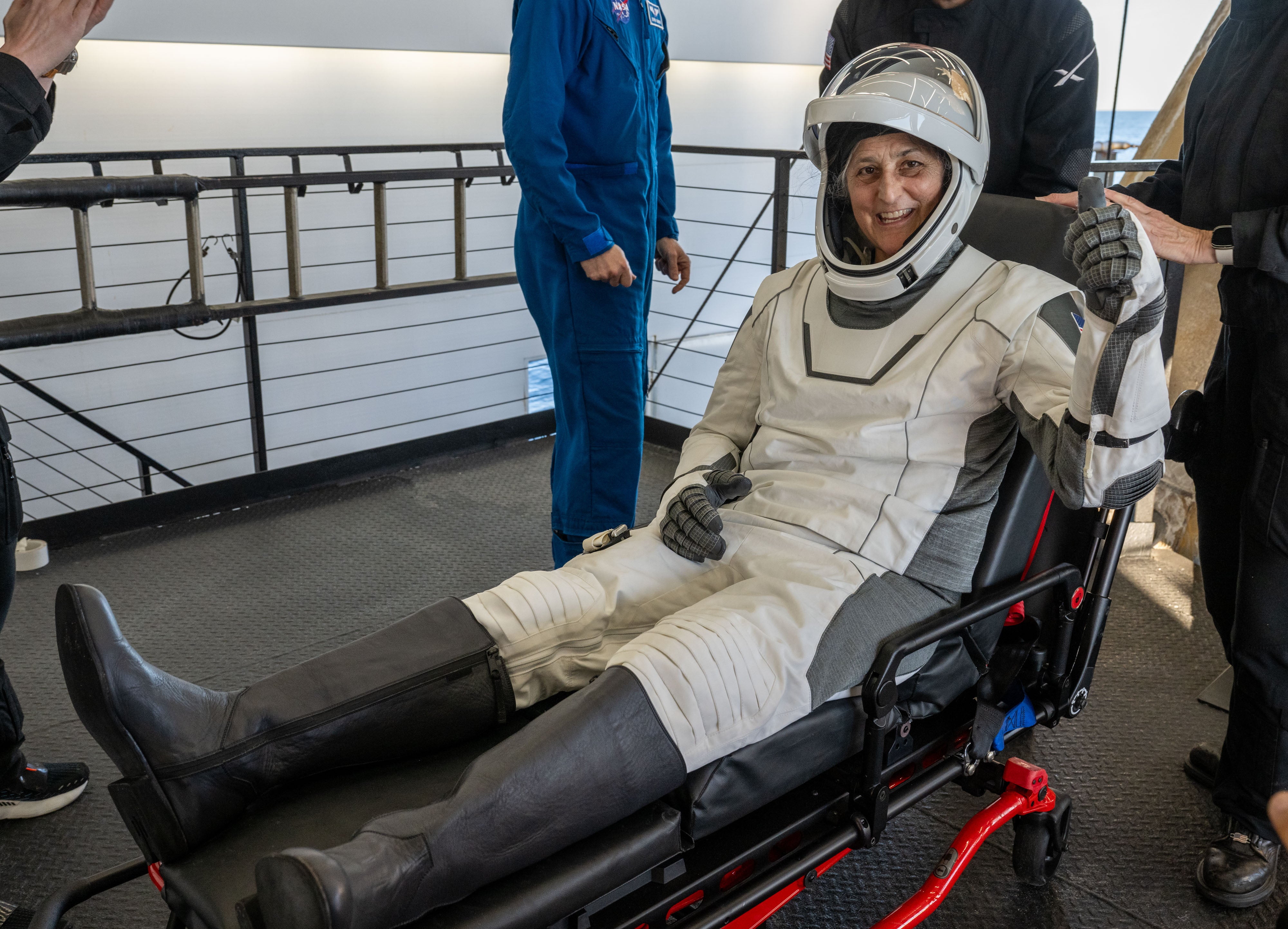 Suni Williams is helped out of a SpaceX Dragon spacecraft