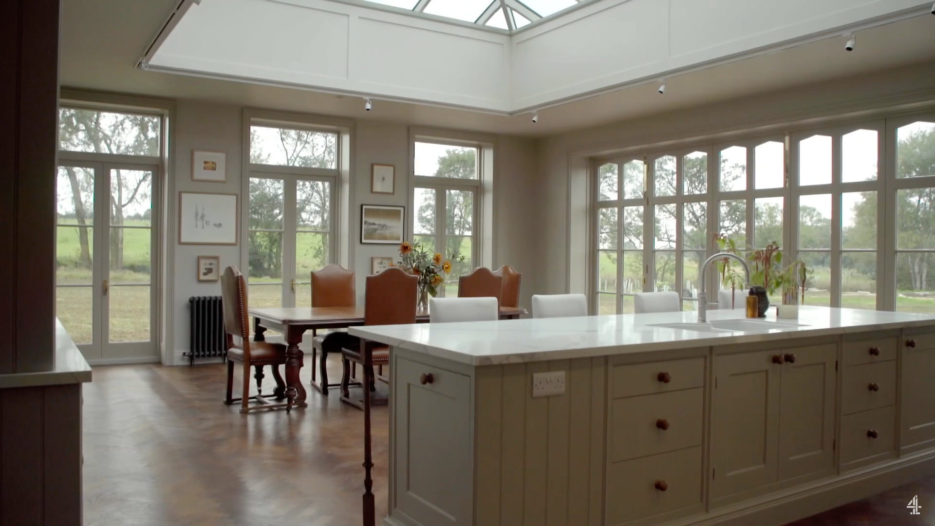 The kitchen in the property features huge windows and kitchen island