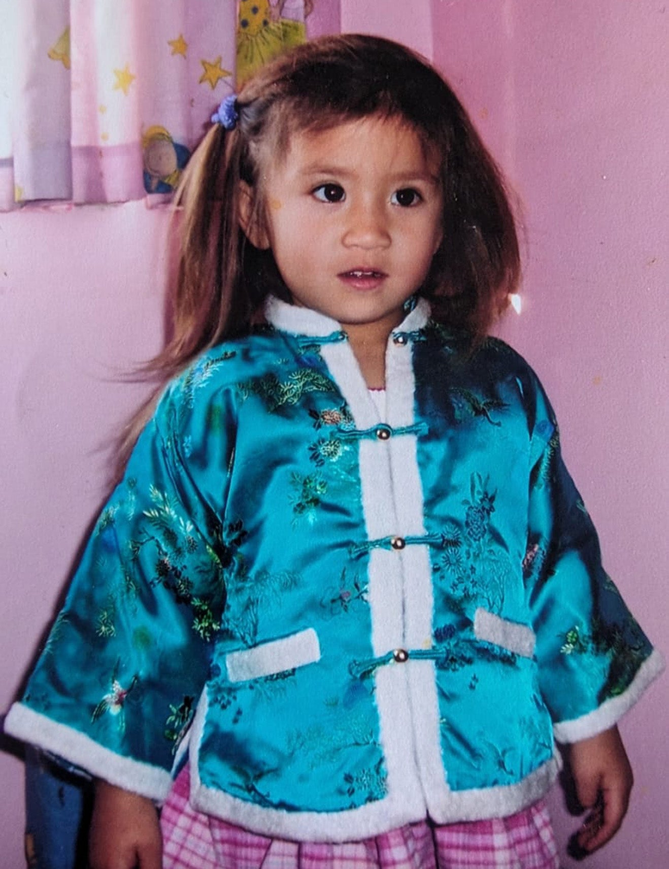 Rachel's daughter, Lucy, wearing the jacket Rachel wore when she flew to the UK to be adopted