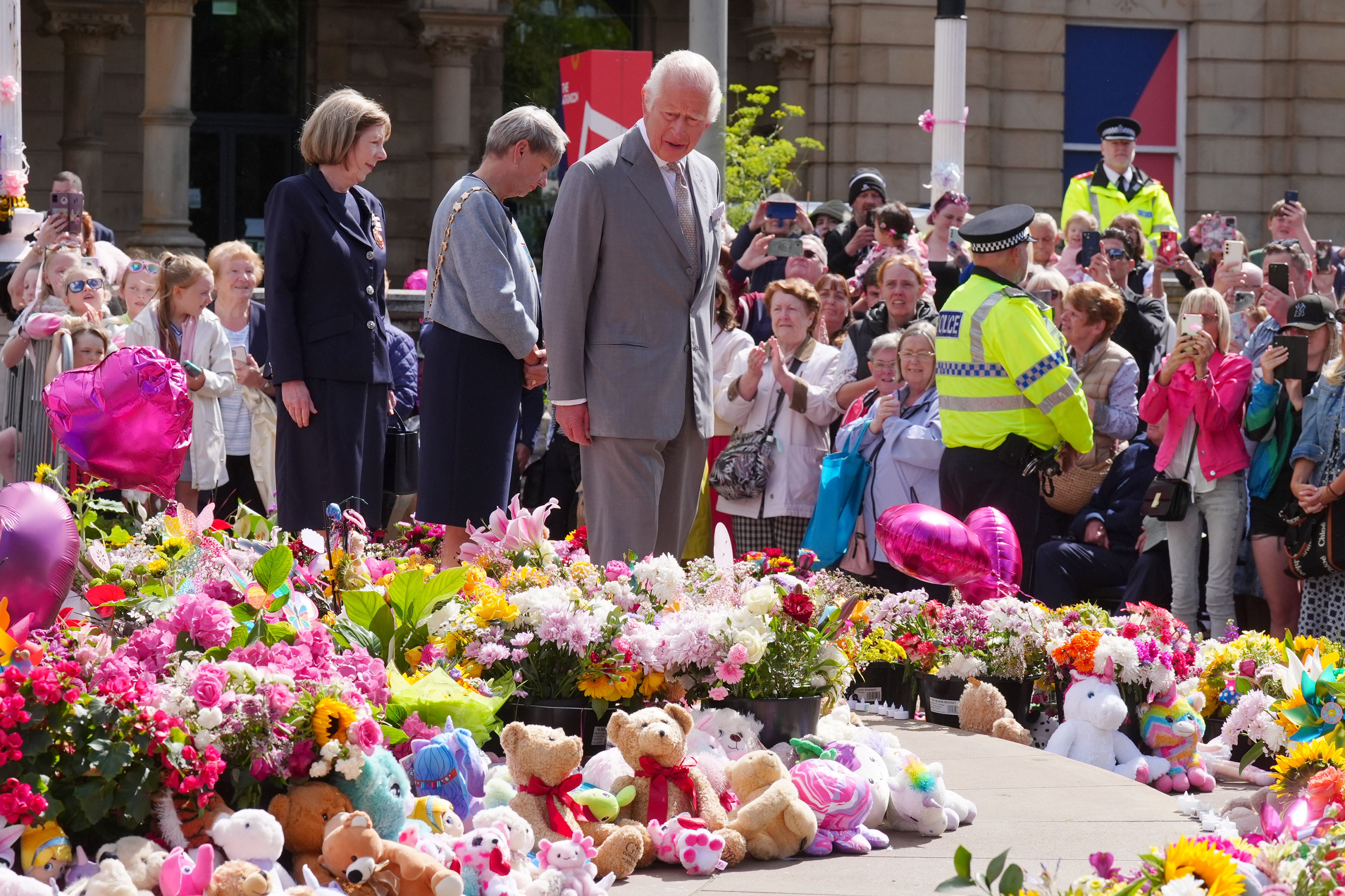 King Charles during a visit to Southport in the aftermath of the attack, where he viewed floral tributes (PA/Owen Humphreys)