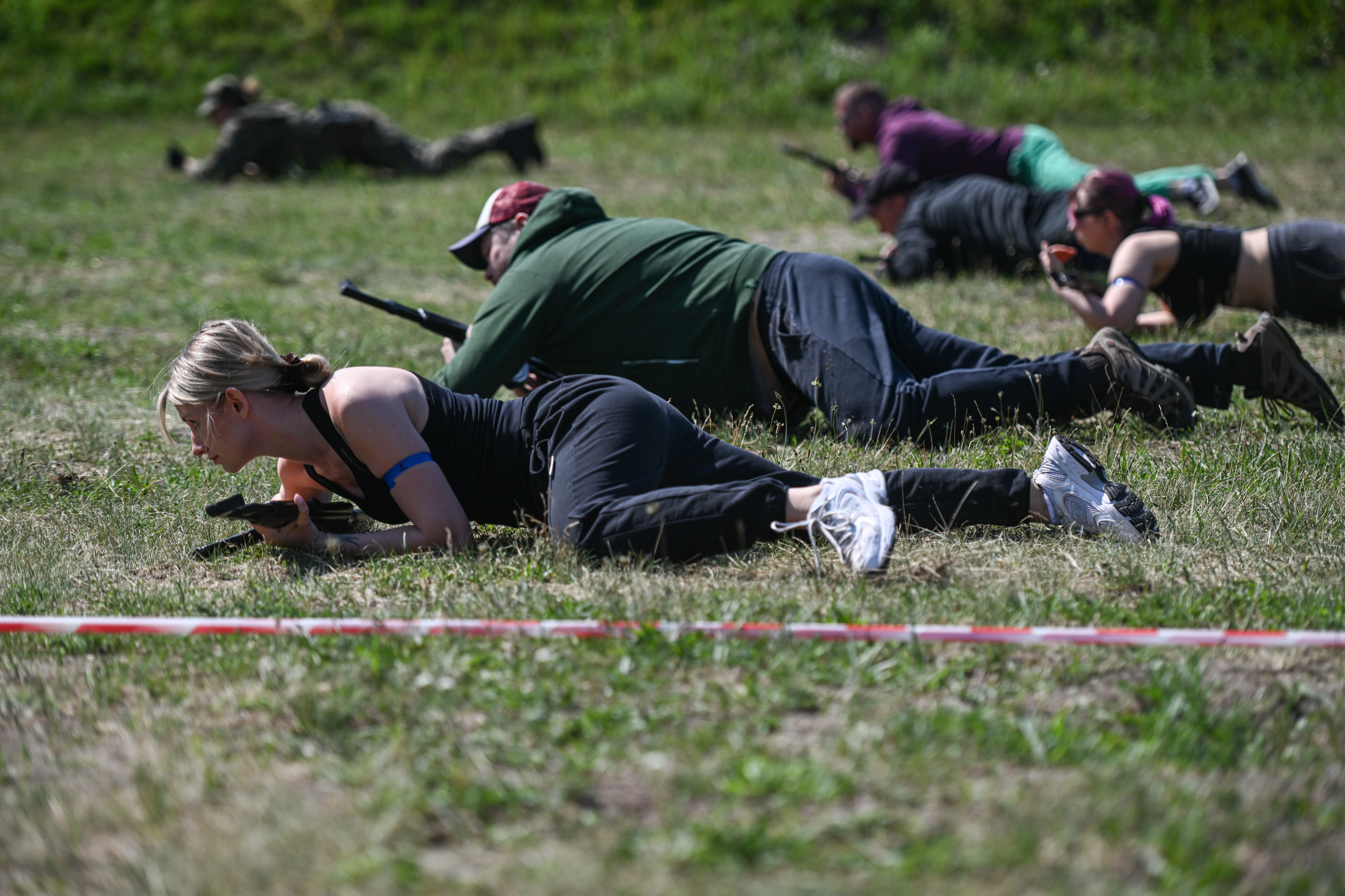 Polish civilians hold plastic rifles as they take part in a military training exercise