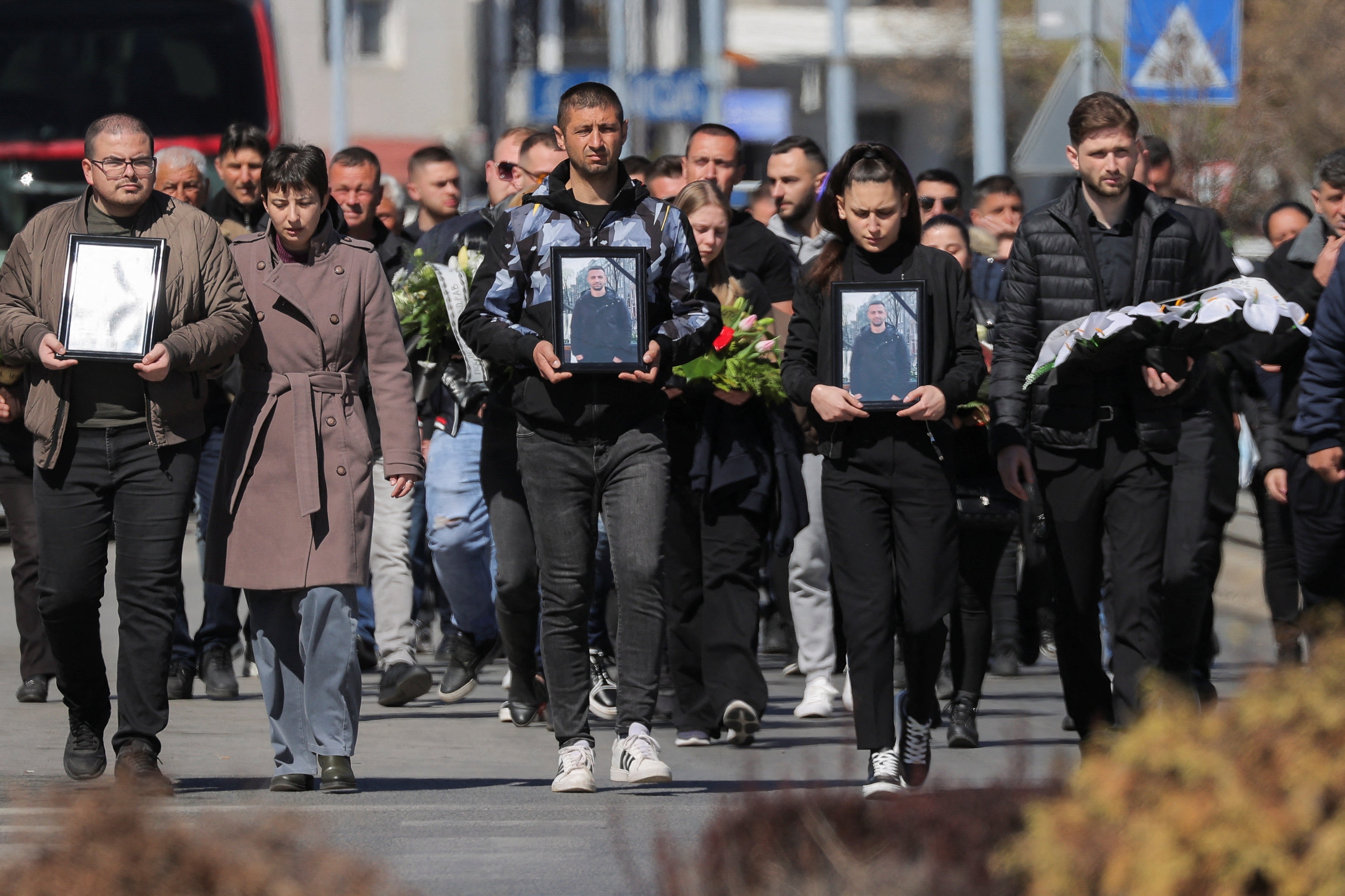 Some in Kocani carried photos of loved ones who died in the blaze