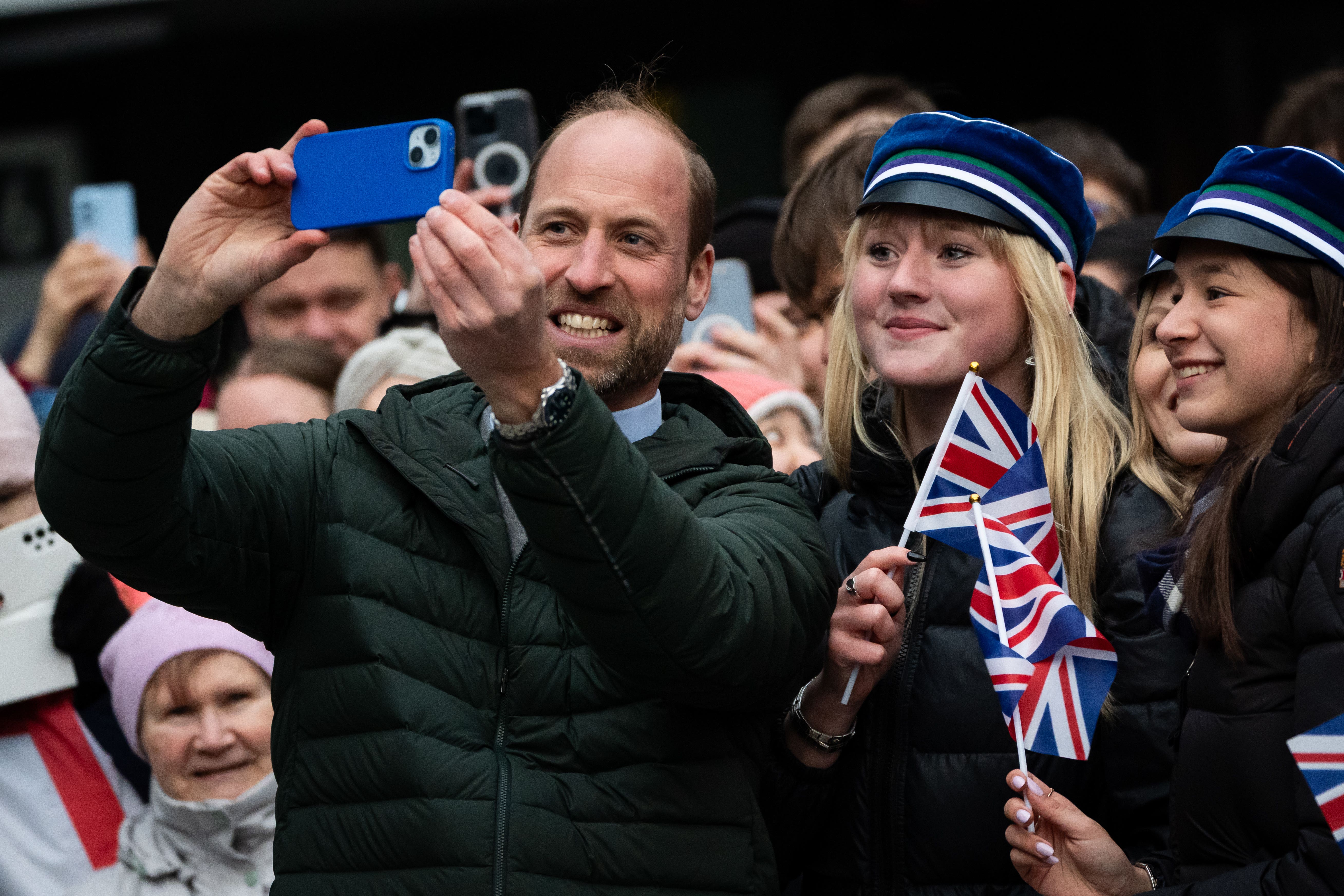 The Prince of Wales takes a selfie during a walkabout to meet members of the public in Tallinn (Aaron Chown/PA)