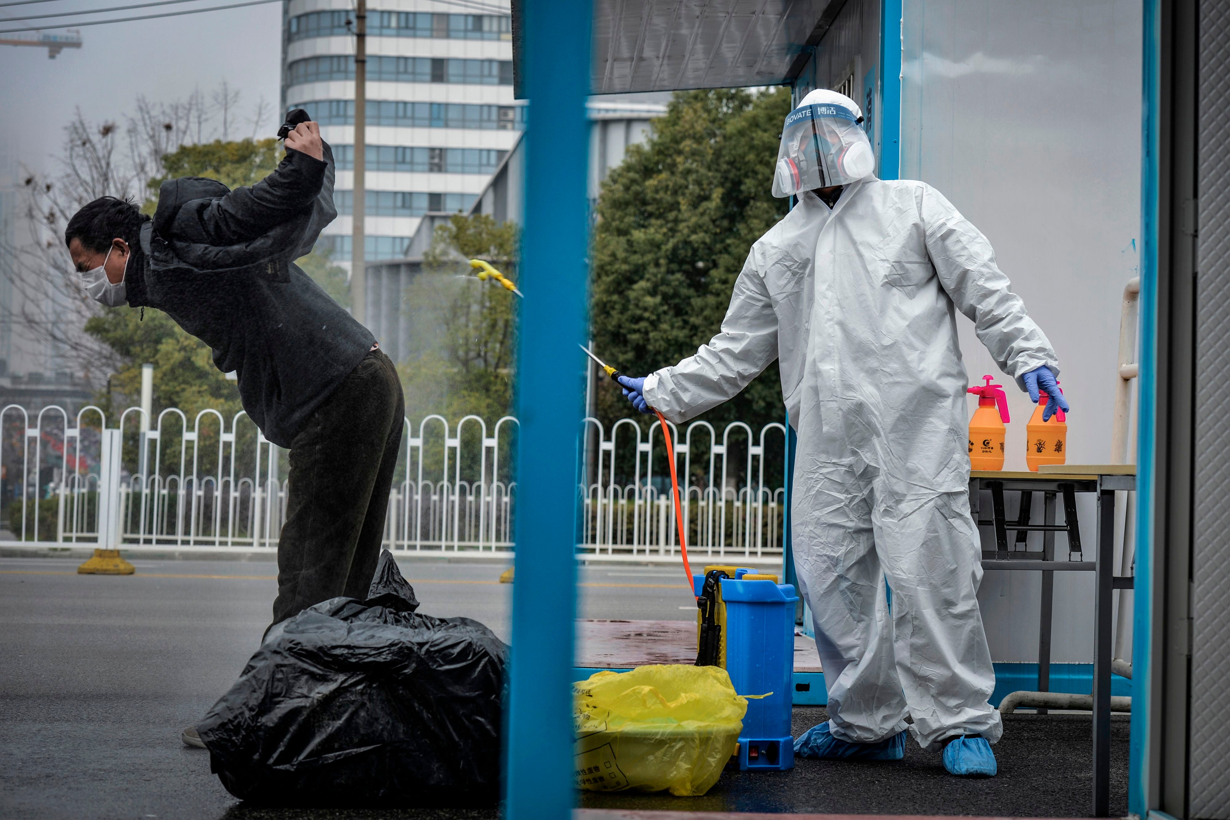 A patient is disinfected after leaving a hospital located in Hubei, Wuhan