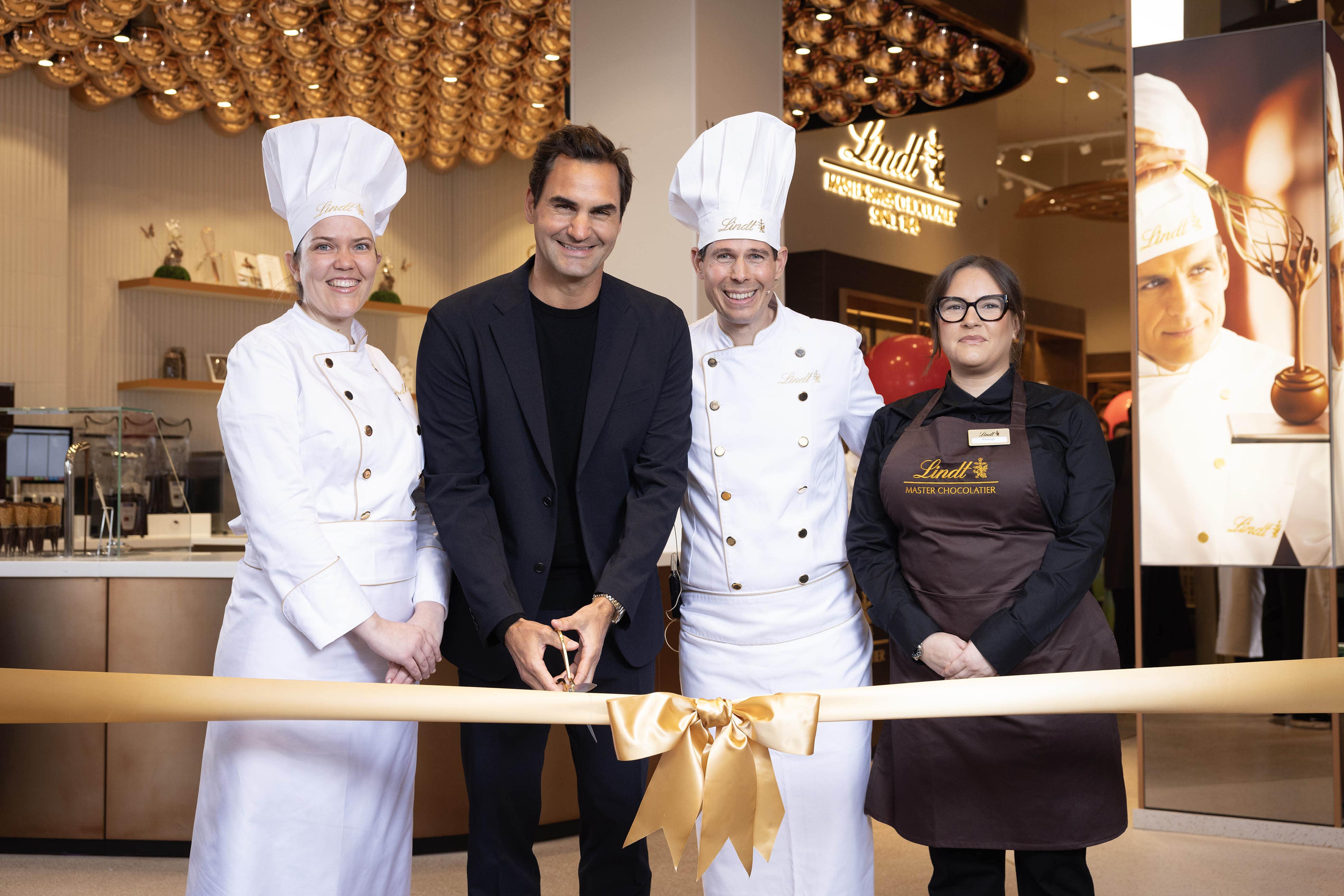 Roger Federer, Lindt’s global ambassador, with master chocolatiers, Miquetta Veda De Castro (left) and Stefan Bruderer (second right), and store manager, Kayleigh Gigg (right) at the grand opening of the new Lindt flagship London store in Piccadilly Circus (Matt Alexander Media Assignments/PA)