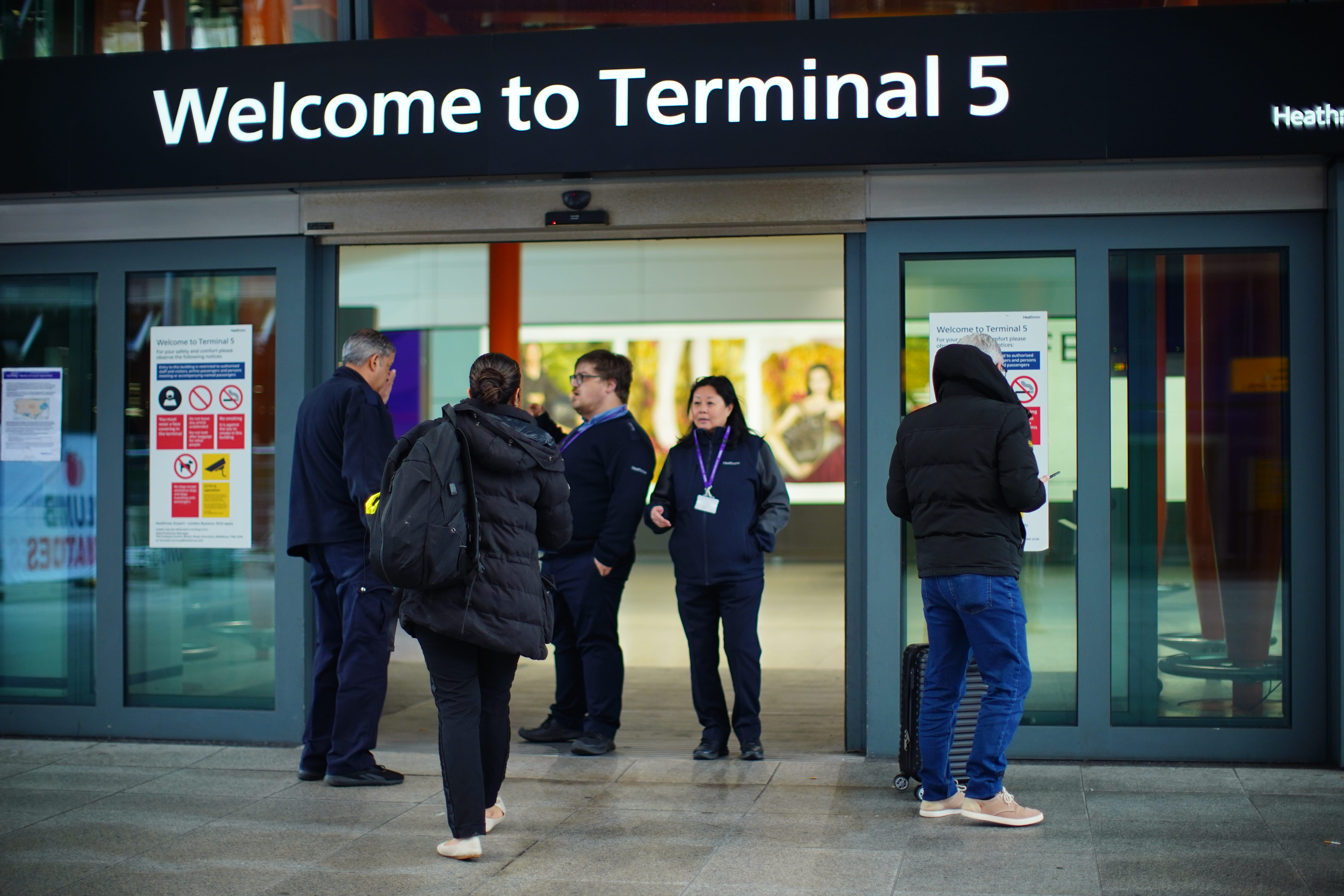 Stranded passengers at Heathrow Terminal 5 in London (James Manning/PA)