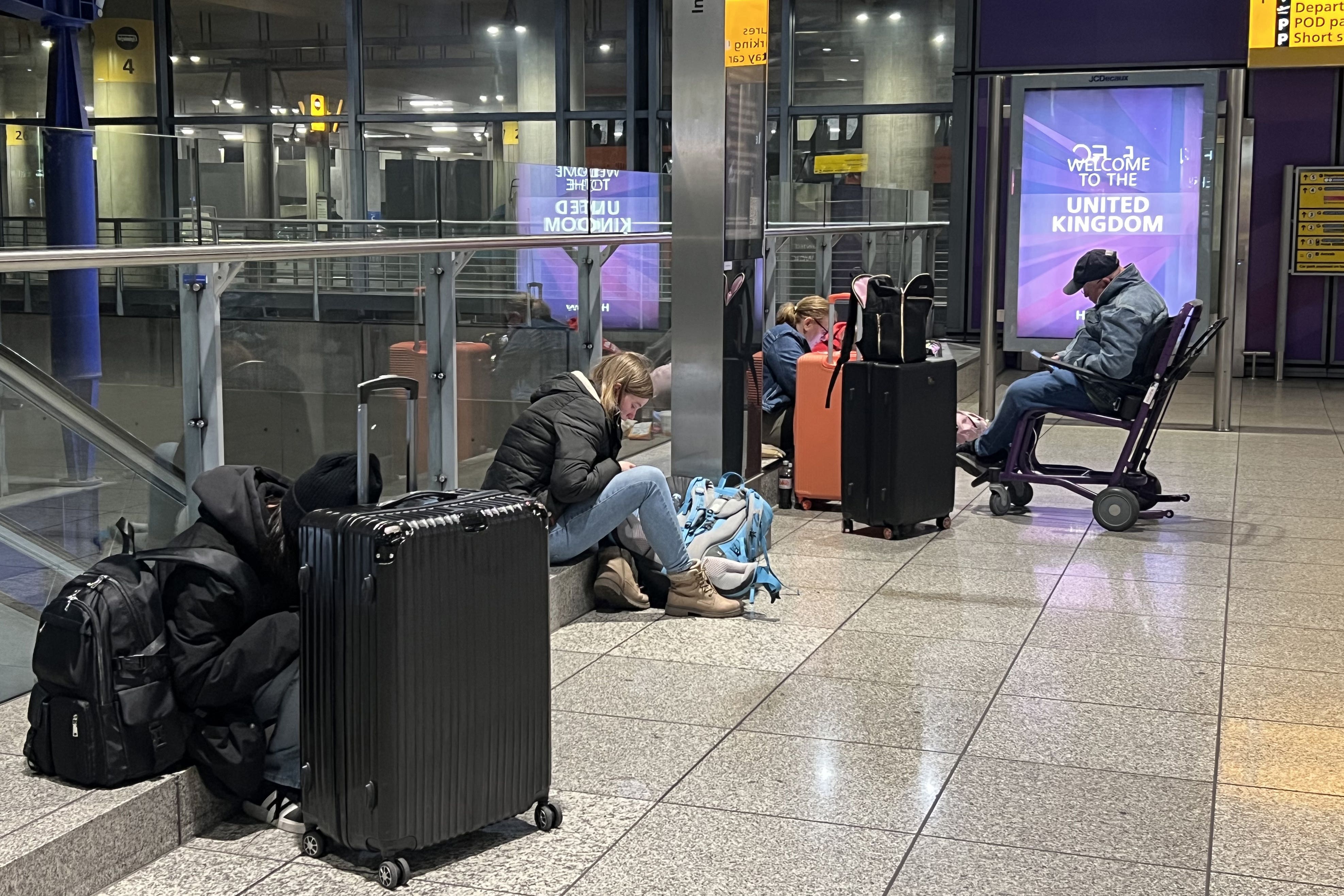 Stranded passengers at Heathrow Terminal 5 in London (Maja Smieijkowska/PA)