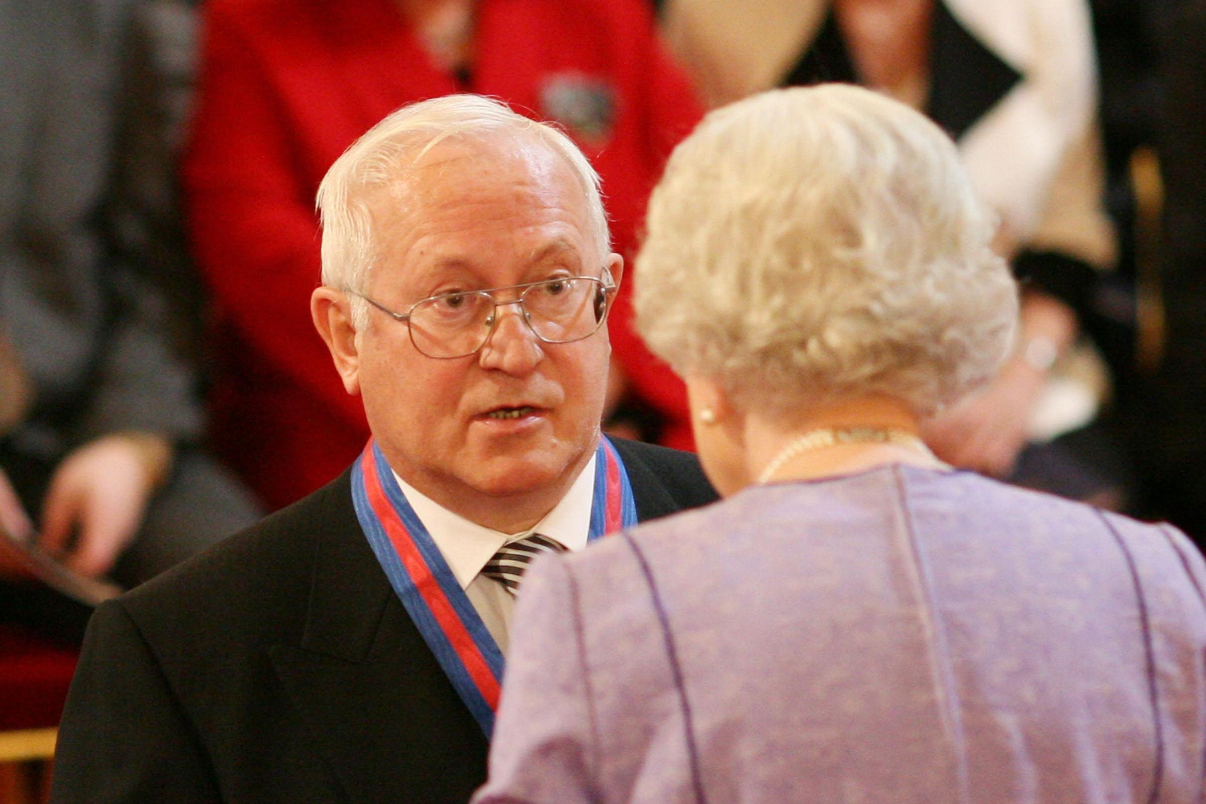 Former Soviet spy Oleg Gordievsky receives the Companion of the Most Distinguished Order of St Michael and Saint George from Queen Elizabeth II at Buckingham Palace (Martin Keene/PA)