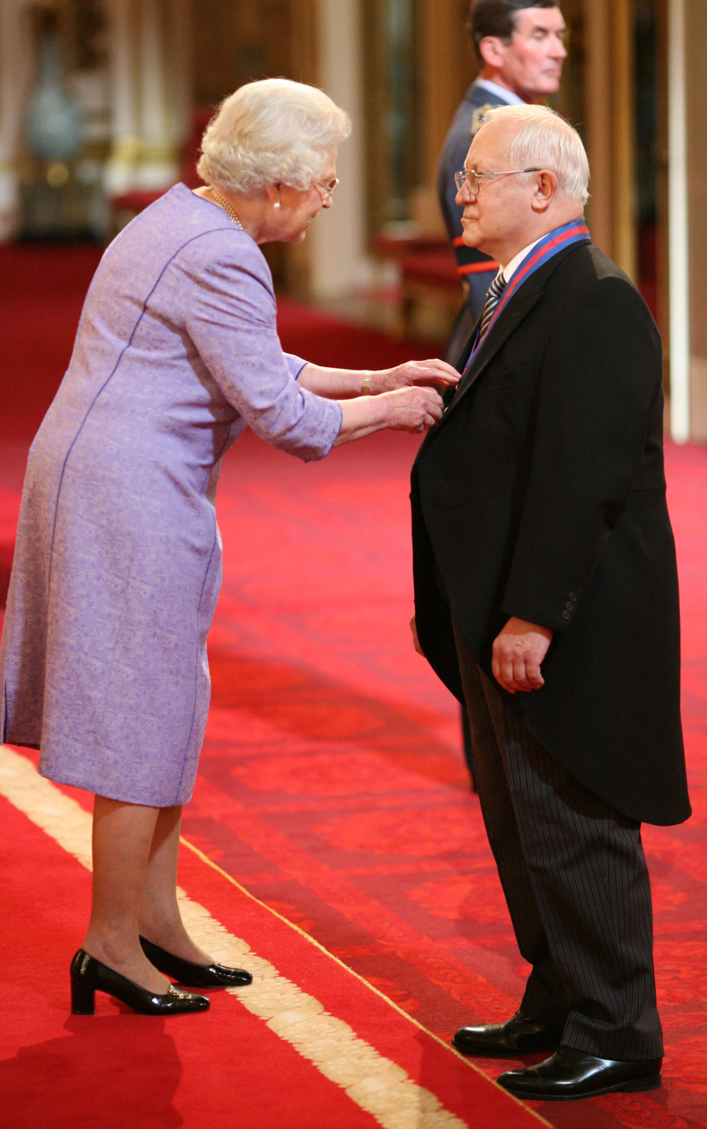Oleg Gordievsky receives the Companion of the Most Distinguished Order of St Michael and Saint George from Queen Elizabeth II at Buckingham Palace