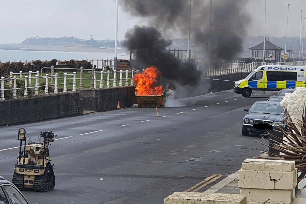 Handout photo issued by Sussex Police of the Explosive Ordnance Disposal (EOD) team carrying out a controlled burn of desensitised chemicals in a skip near the sea wall in St Leonards, East Sussex following the discovery of explosive chemicals in a property (Sussex Police/PA)