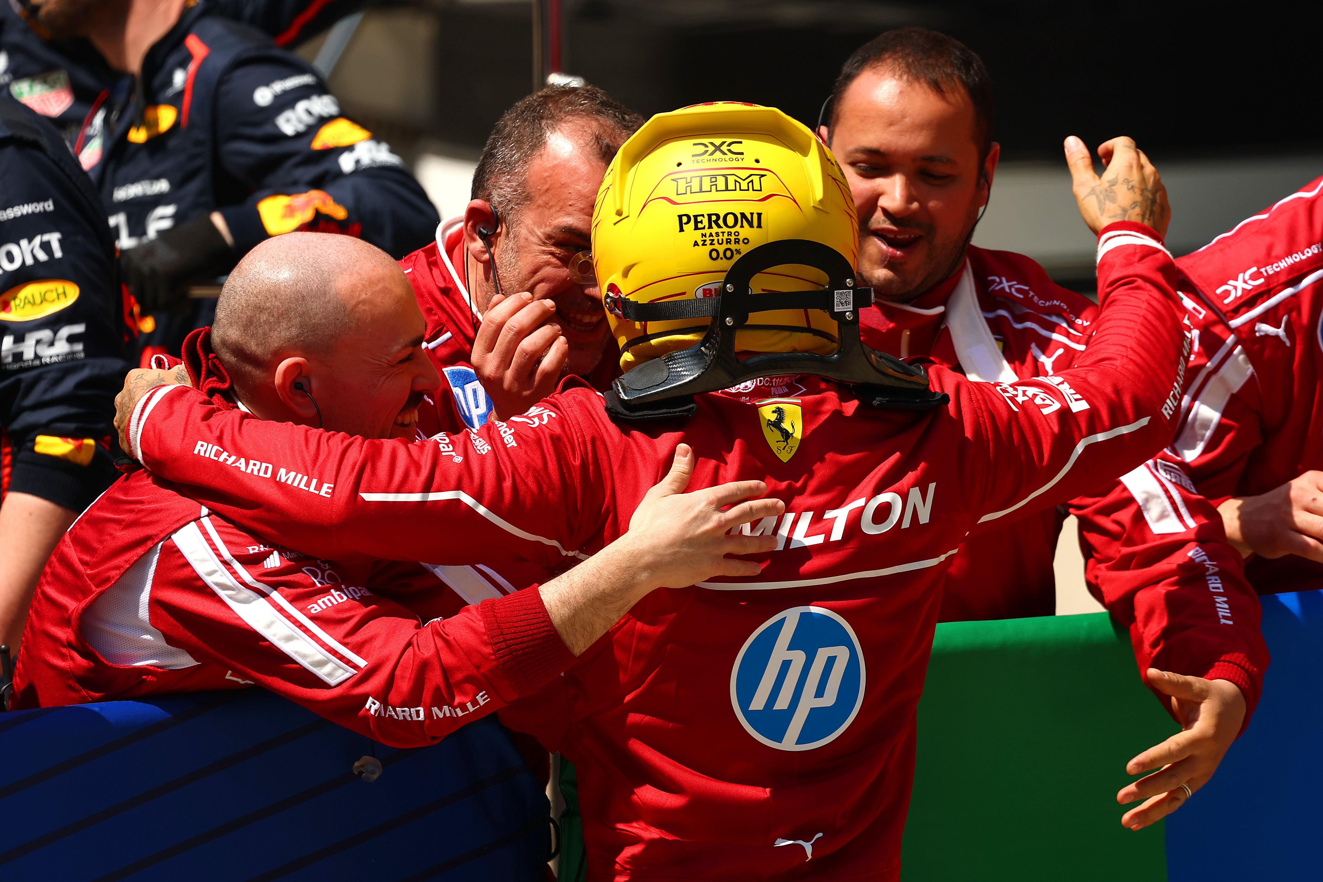 Hamilton celebrates his win with his Ferrari team