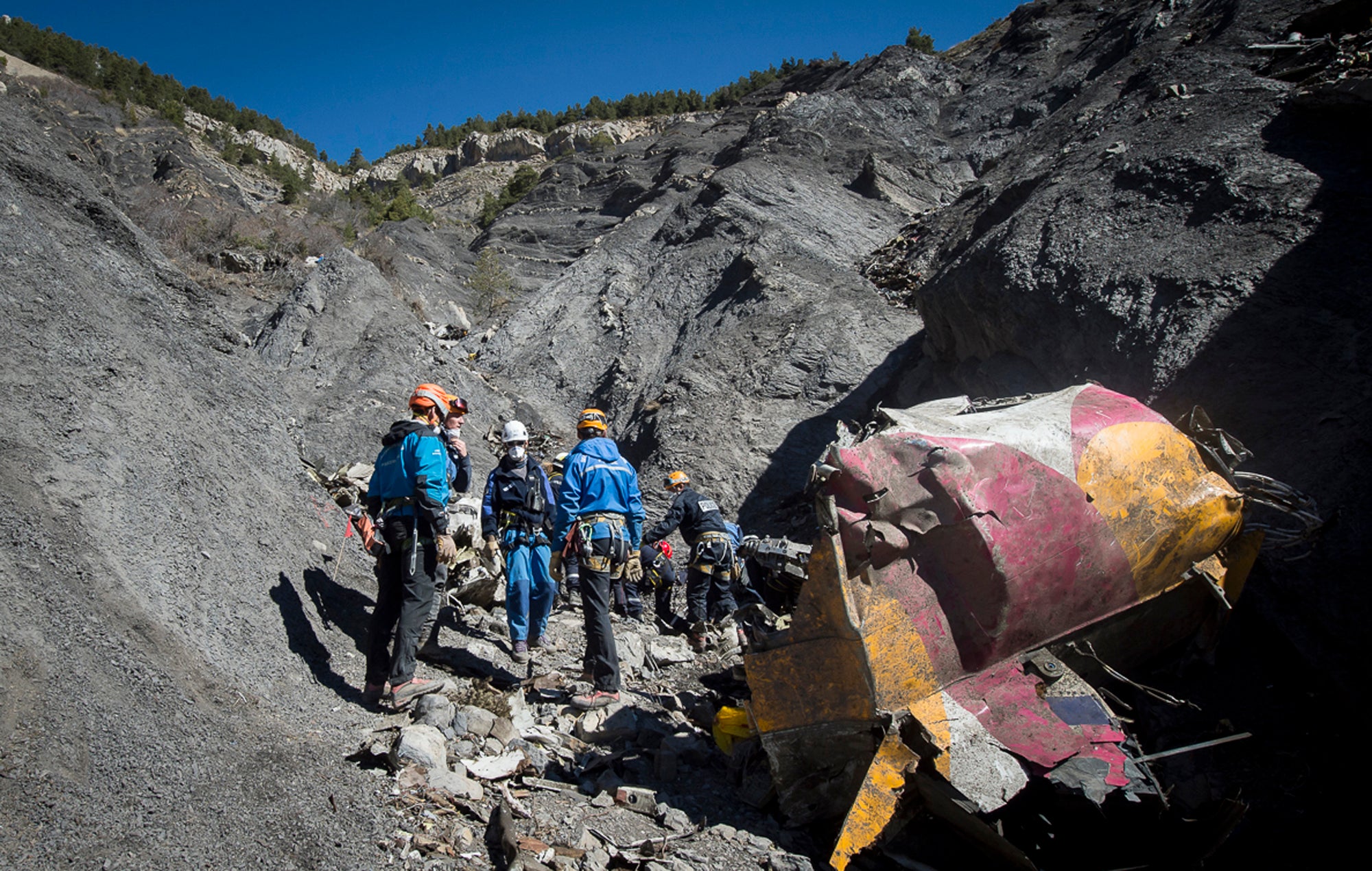 French emergency workers pick among the debris of the Germanwings flight