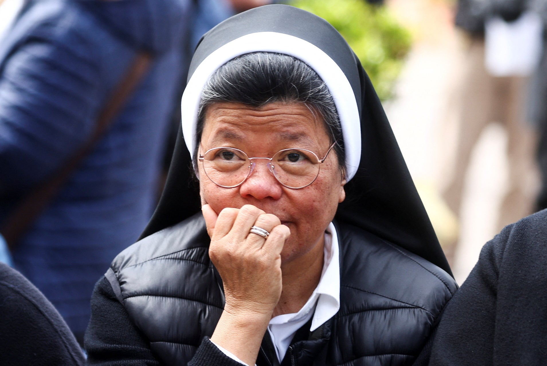 A nun waits for Pope Francis’ first public appearance in five weeks