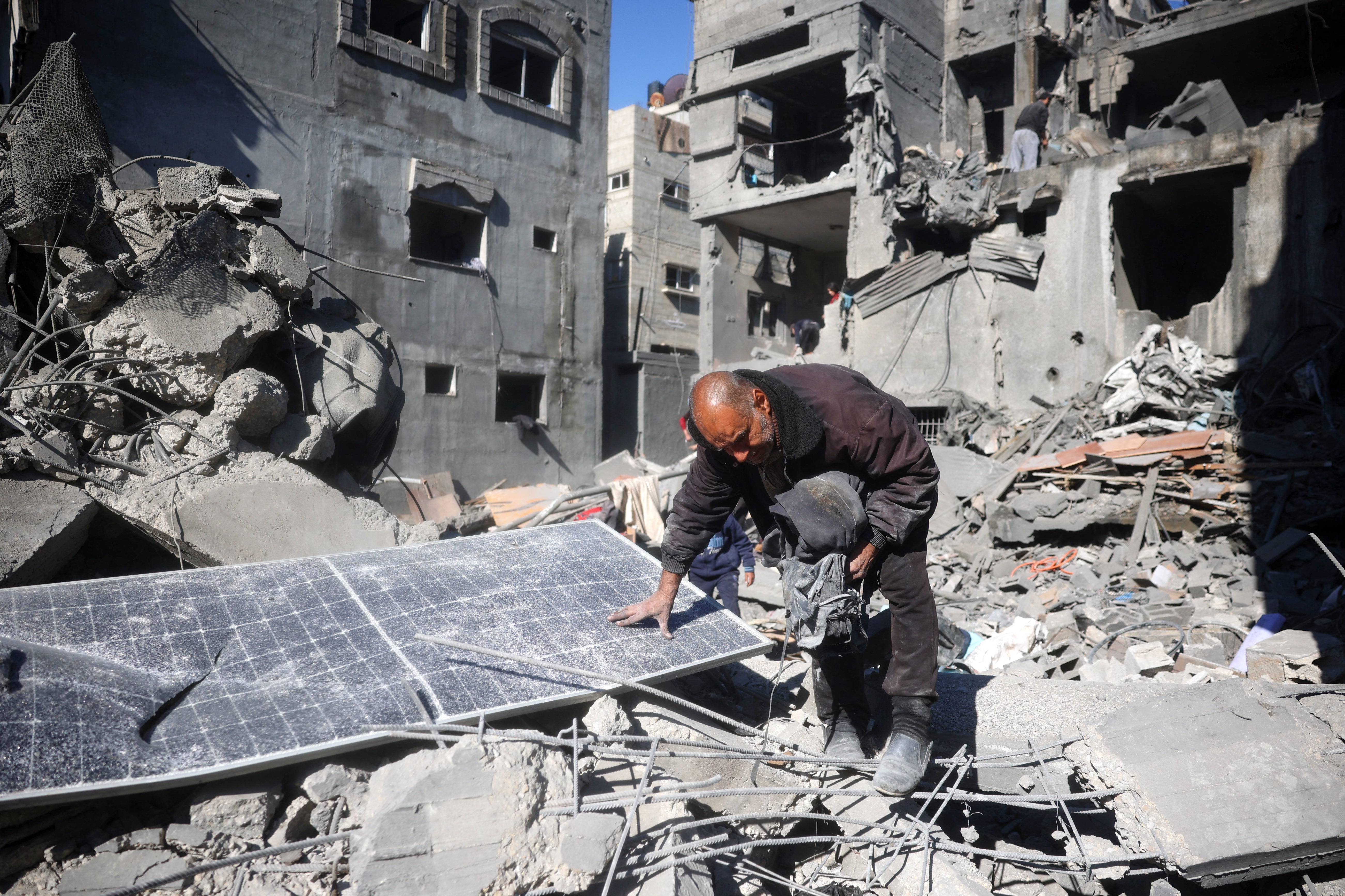 A Palestinian man walk overs the rubble and debris at the site of Israeli strikes the night before at the Nuseirat refugee camp in the central Gaza Strip